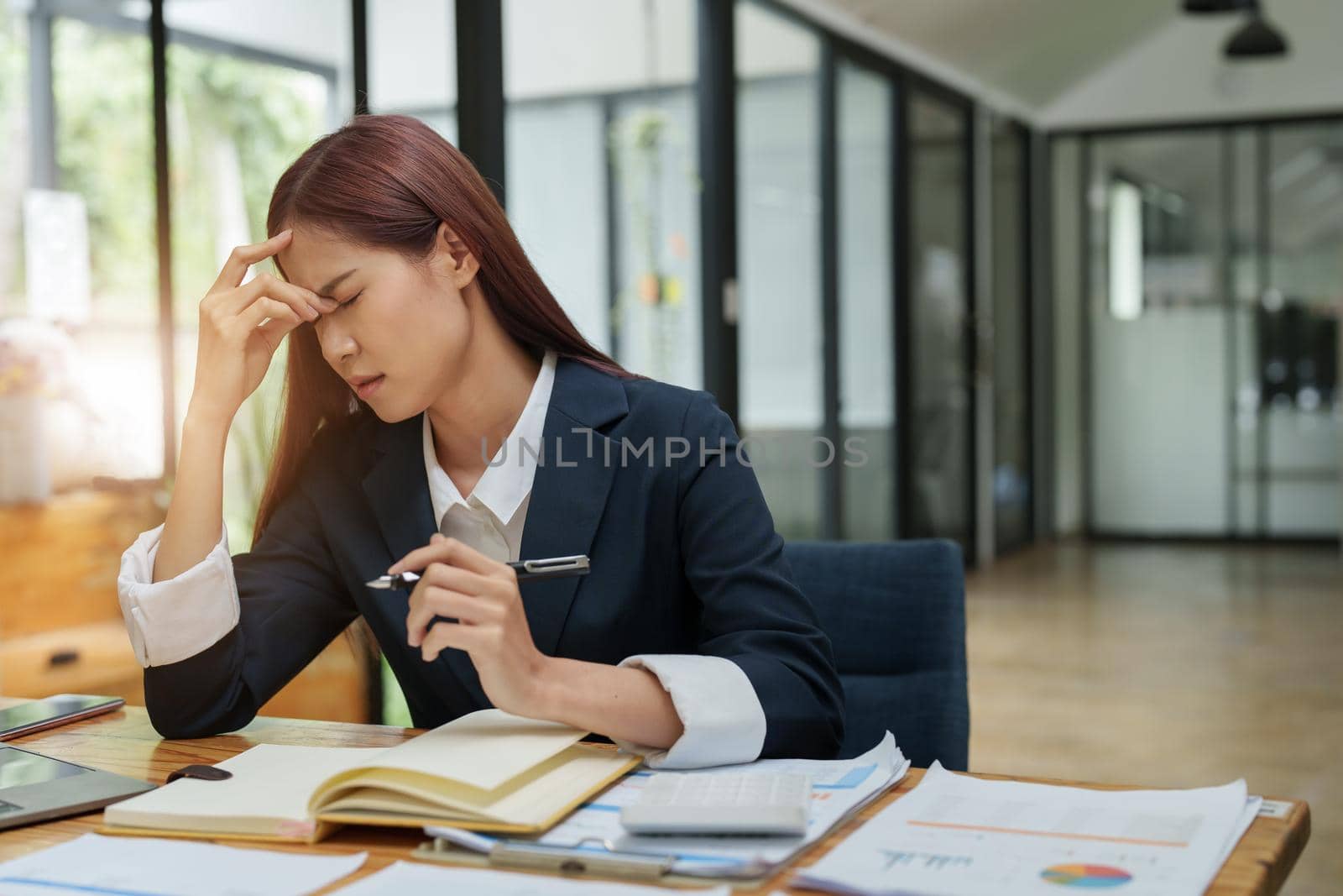 businesswoman showing a serious expression while talking on the phone.