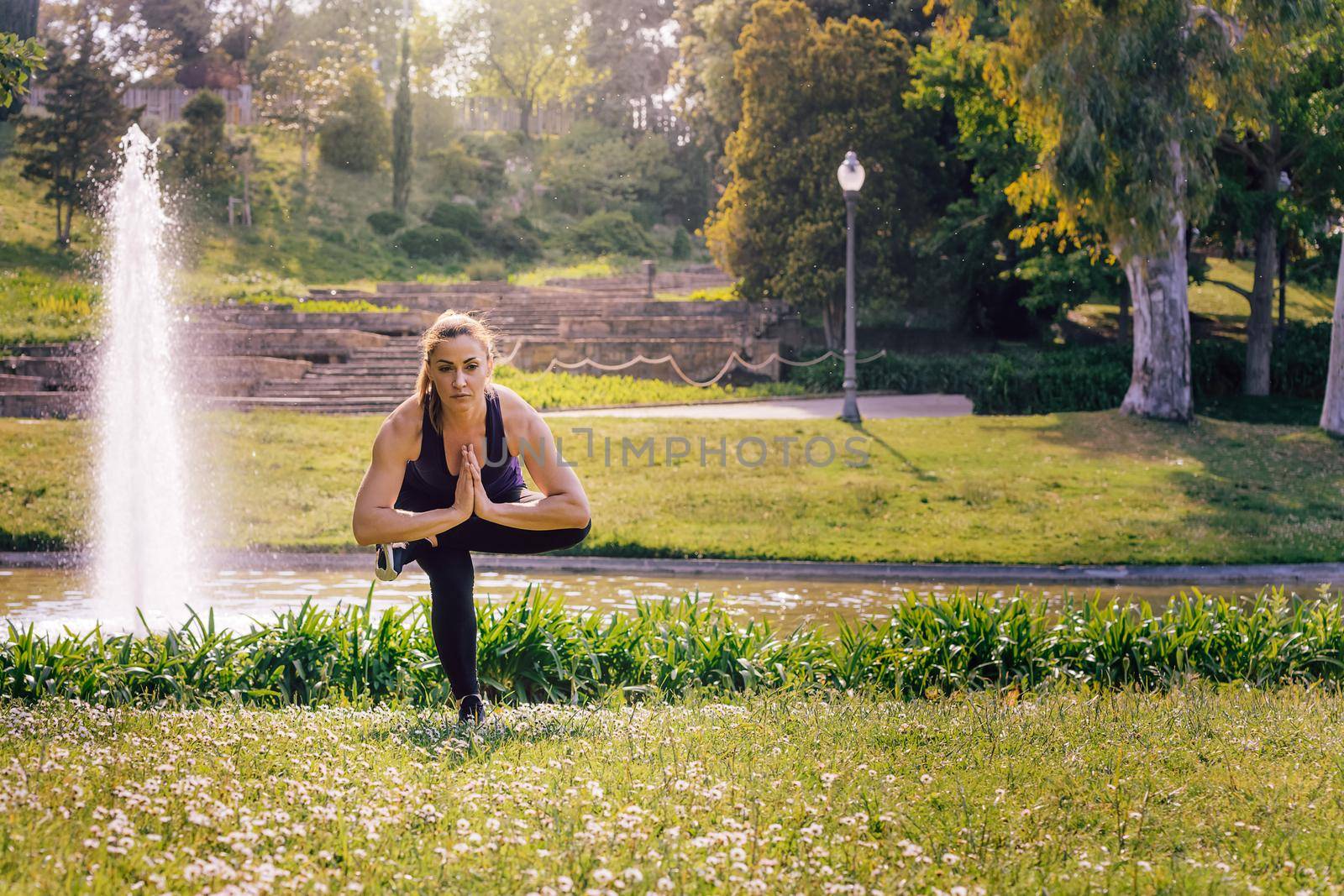 young woman doing yoga exercises at nature by raulmelldo