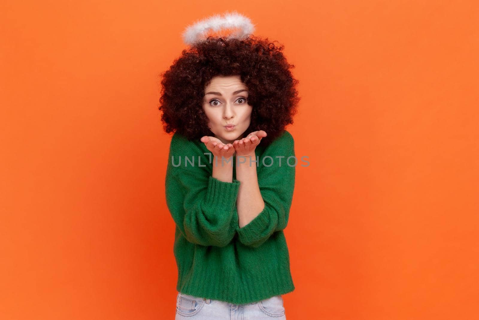 Angelic woman with Afro hairstyle wearing green casual style sweater and nimbus over head sending air kisses, expressing love and romance. by Khosro1