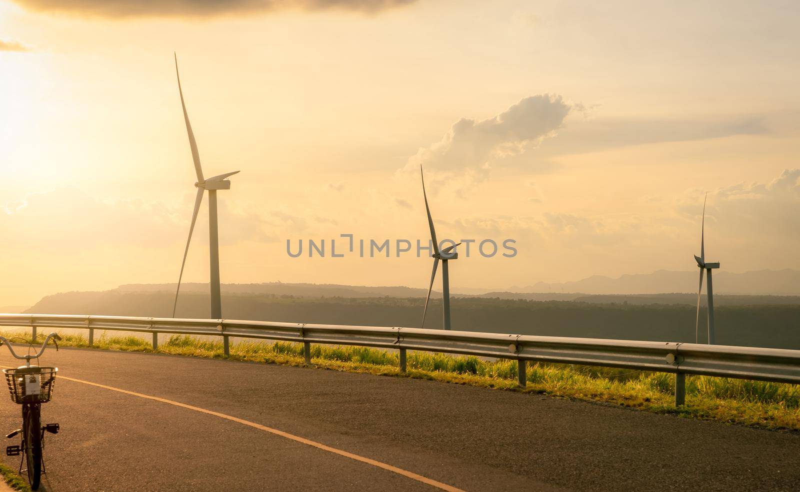 Wind energy. Wind power. Sustainable, renewable energy. Wind turbines generate electricity. Windmill farm on a mountain with blue sky. Green technology. Renewable resource. Sustainable development. by Fahroni