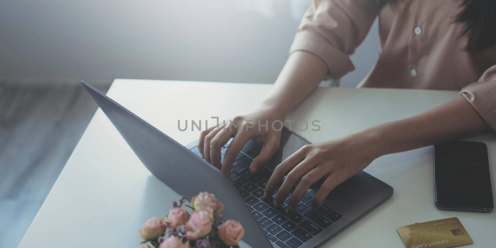 Businesswoman using laptop computer keyboard at the office..