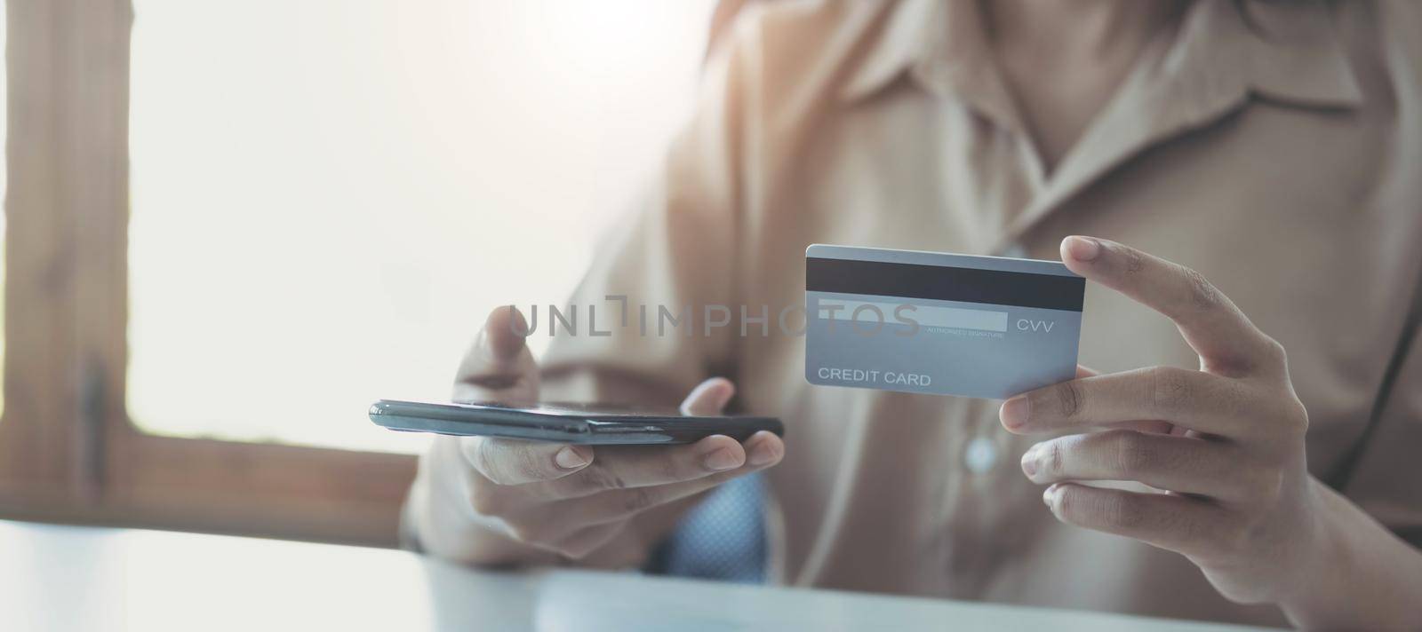 Woman hands holding smartphone shopping online with credit card. Online Payment. Online shopping concept..