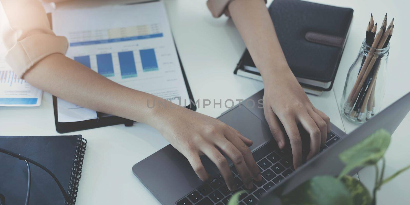 Business woman sitting using laptop computer with on the desk in the office..