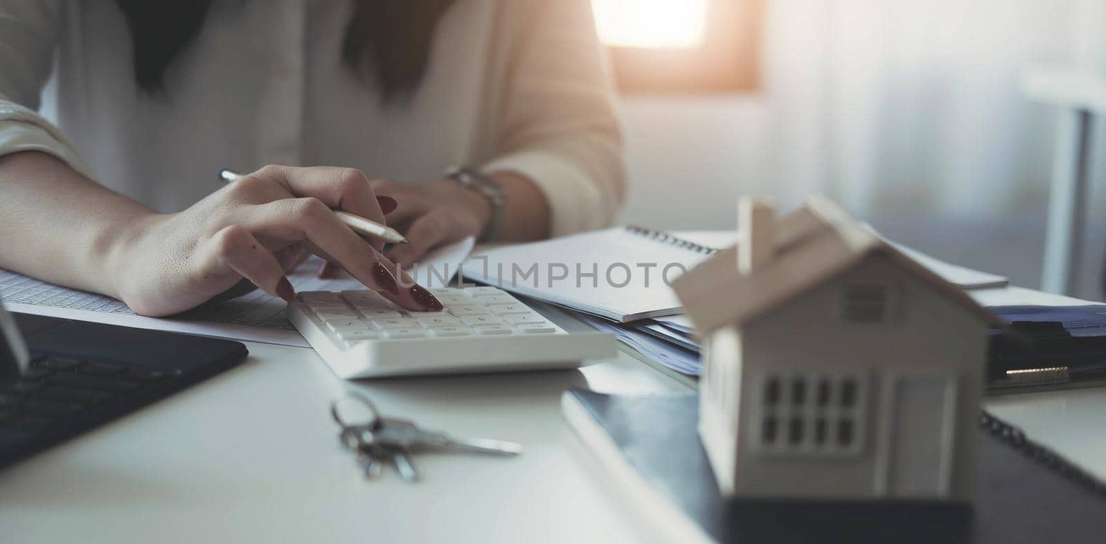 Buying and selling houses and real estate prices concept. woman using calculator to count rent, money or home insurance cost. Calculating mortgage, loan or investment..