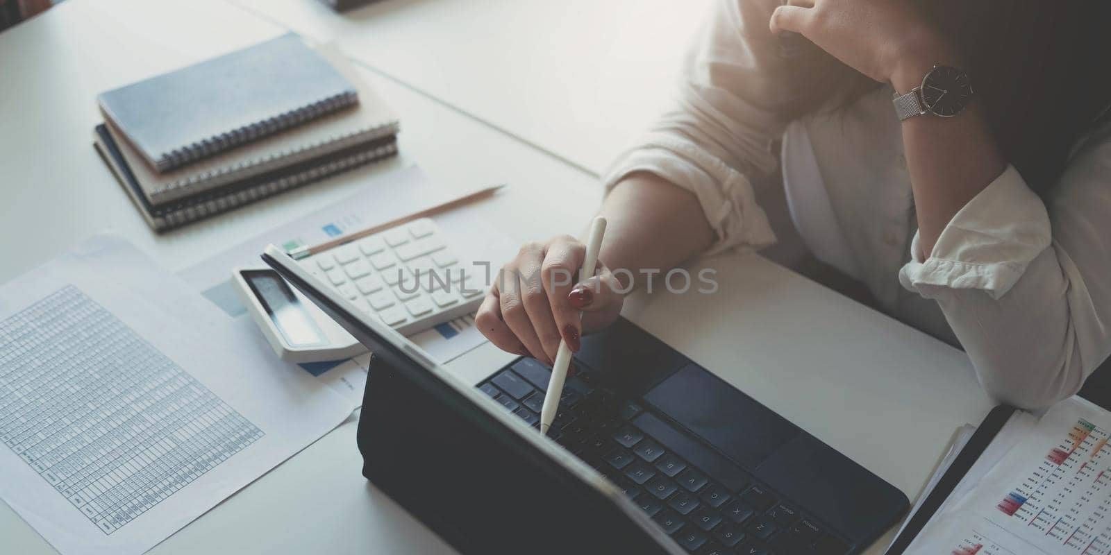 Businesswoman using laptop computer keyboard at the office..