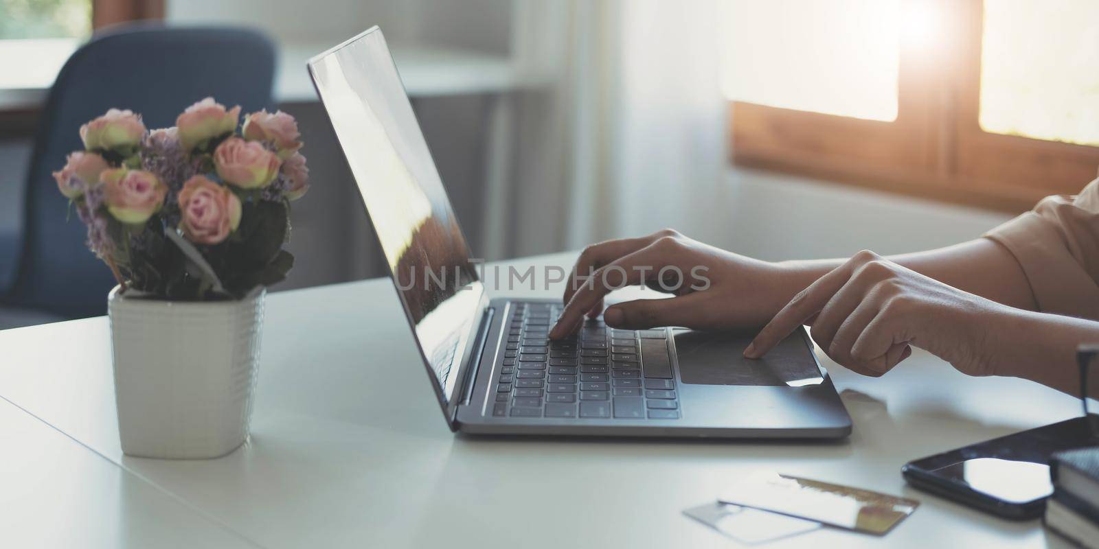 Businesswoman using calculator and laptop computer for analysis maketing plan, Accountant calculate financial report, computer with graph chart. Business, Finance and Accounting concept by wichayada