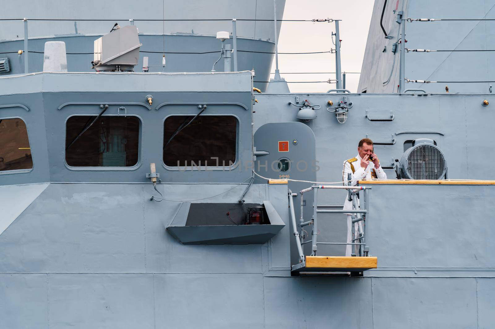 Russia, St. Petersburg, 31 July 2022: The commander of a warship standing in the center of the city, he is dressed in a festive white uniform, celebration of the day of Navy. High quality photo