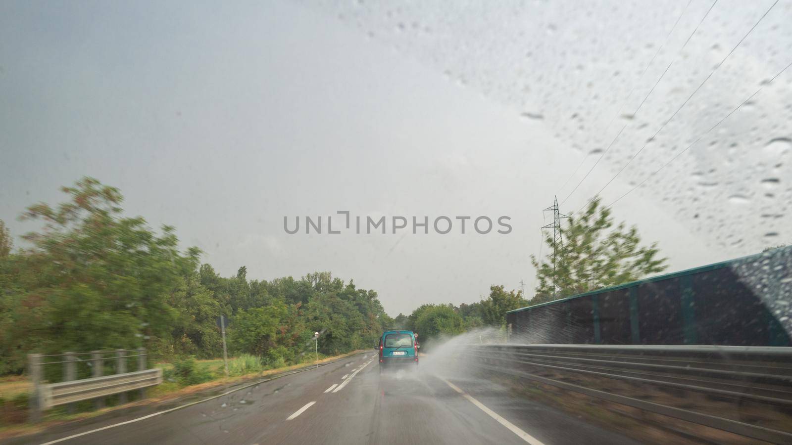 driving in rainy wether view from inside car by verbano