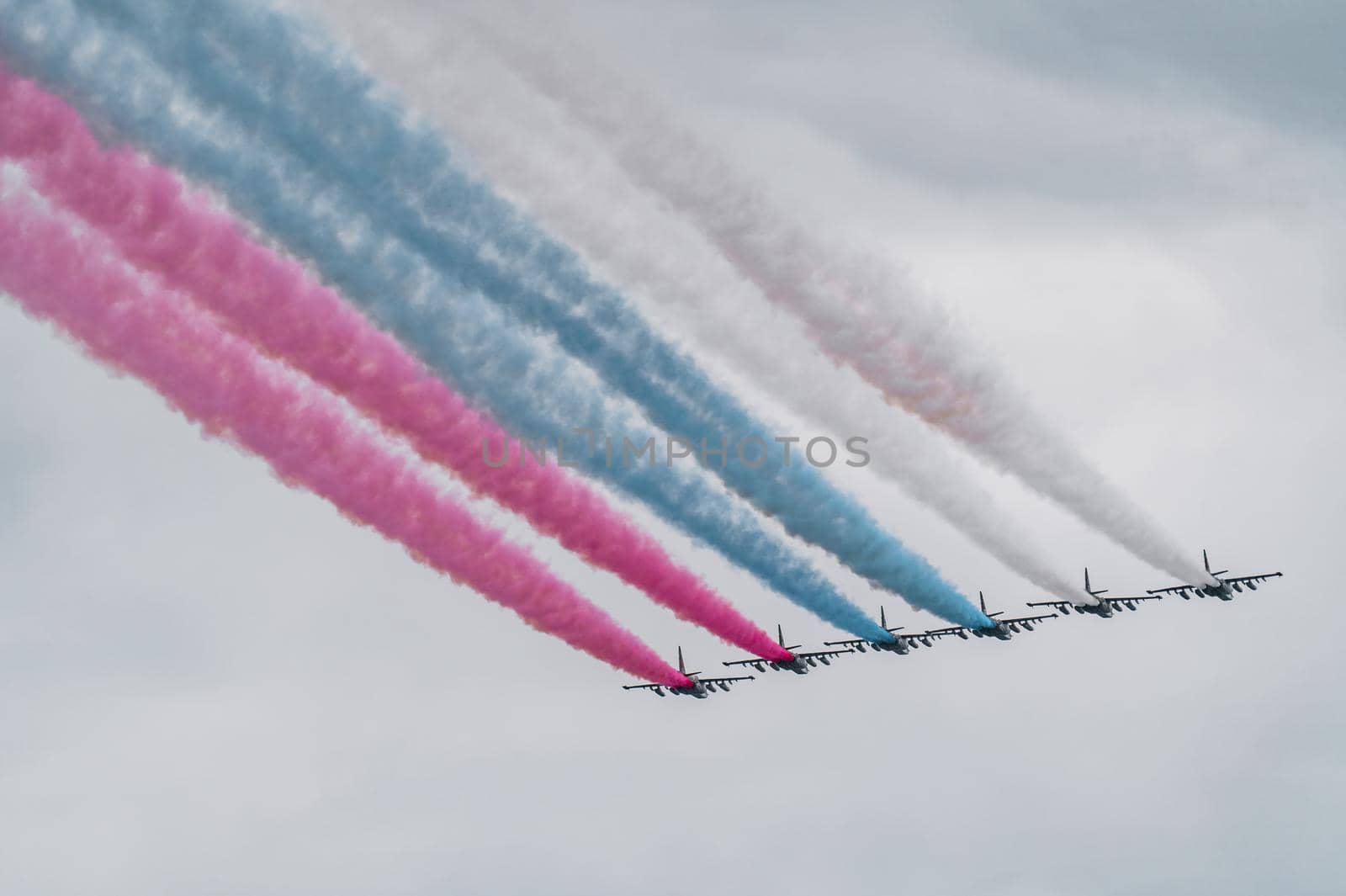 Russian Air Force planes paint the colors of the Russian flag in the sky on St. Petersburg during the celebration of the Day of the Navy. High quality photo