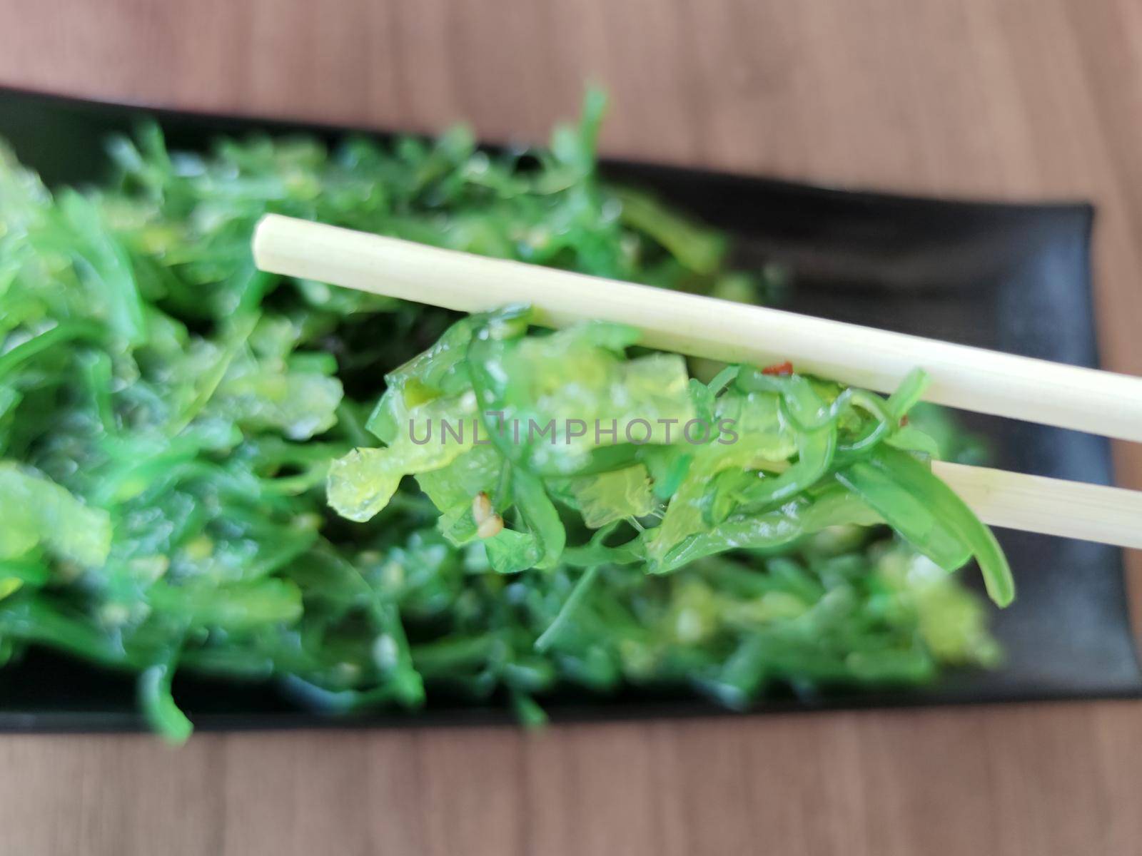 seaweed with sesame seeds and japanese wooden sticks close-up