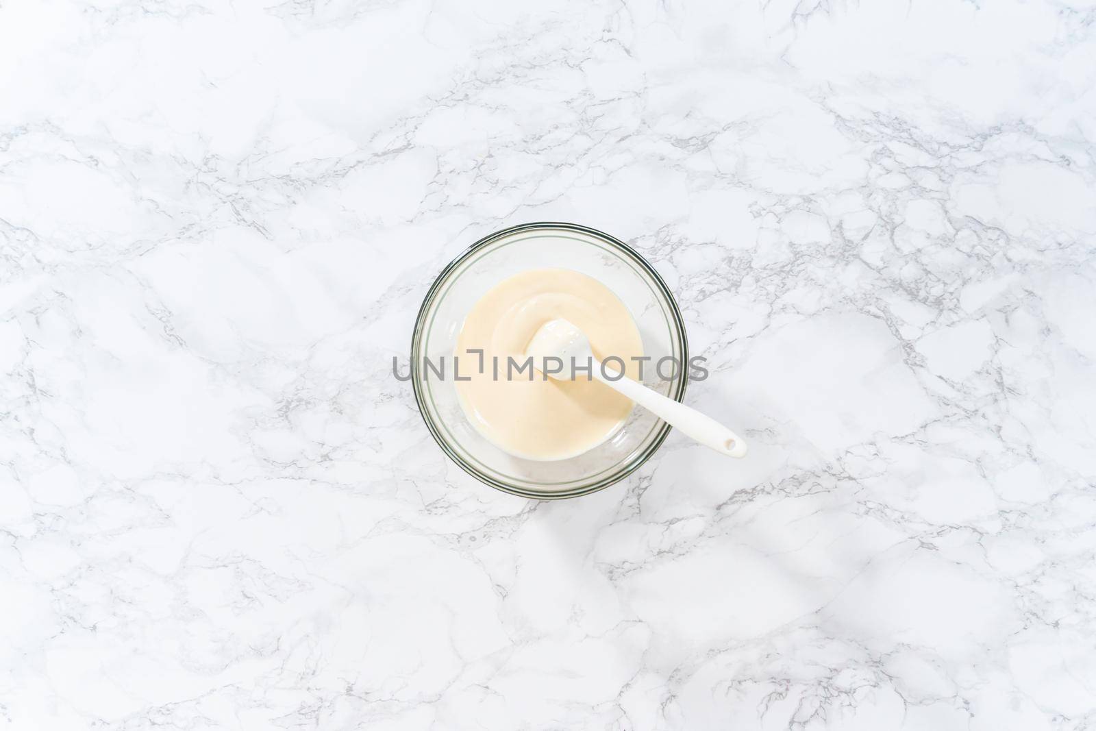 Flat lay. Melting white chocolate chips in a candy melting pot to bake peppermint white chocolate cookies.