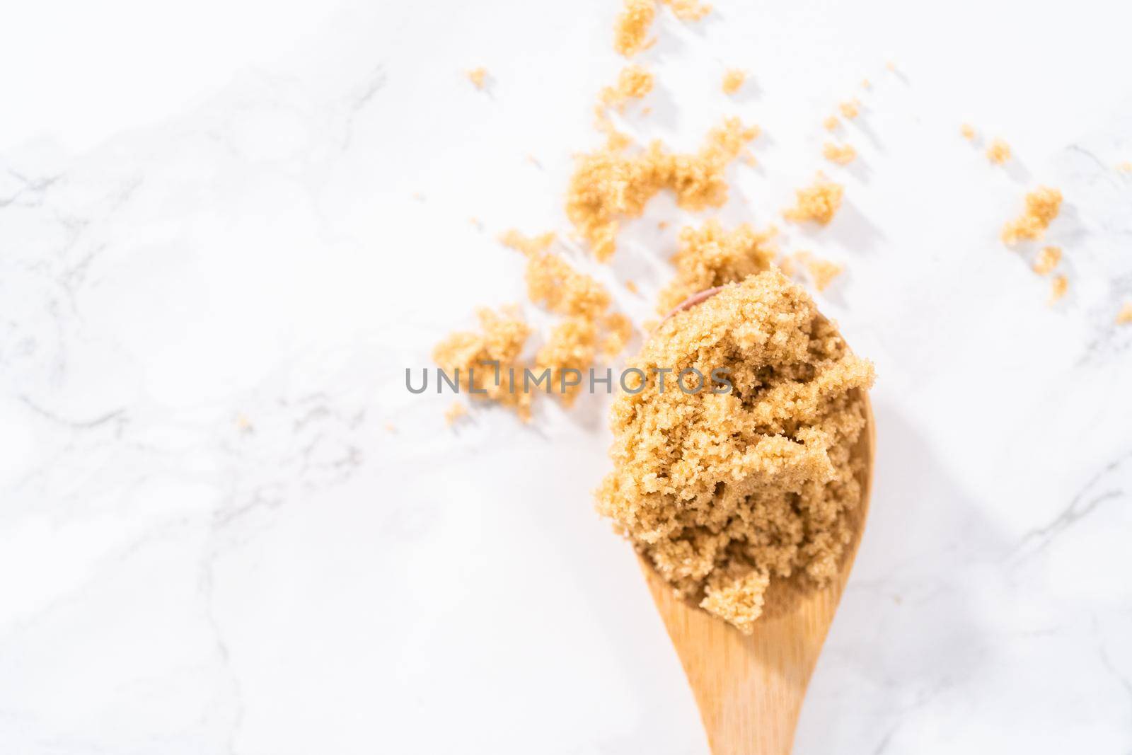 Light brown sugar on a marble counter top.