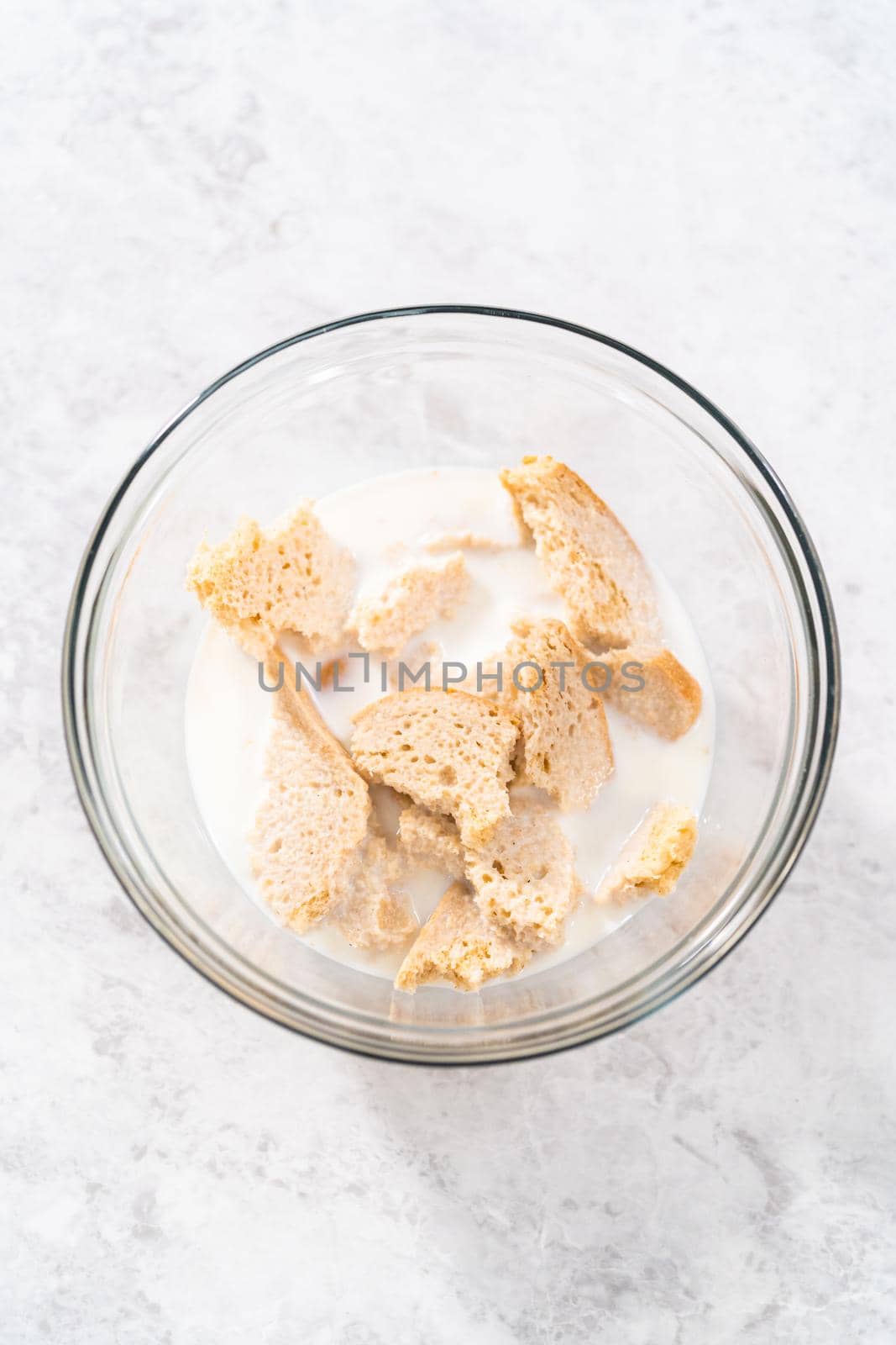 Soaking stale bread in milk to make meatloaf.