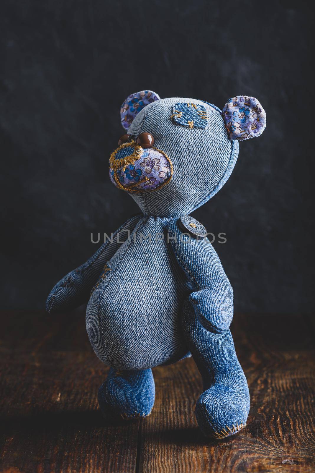 Close Up of Jeans Bear Toy Standing on Wooden Table