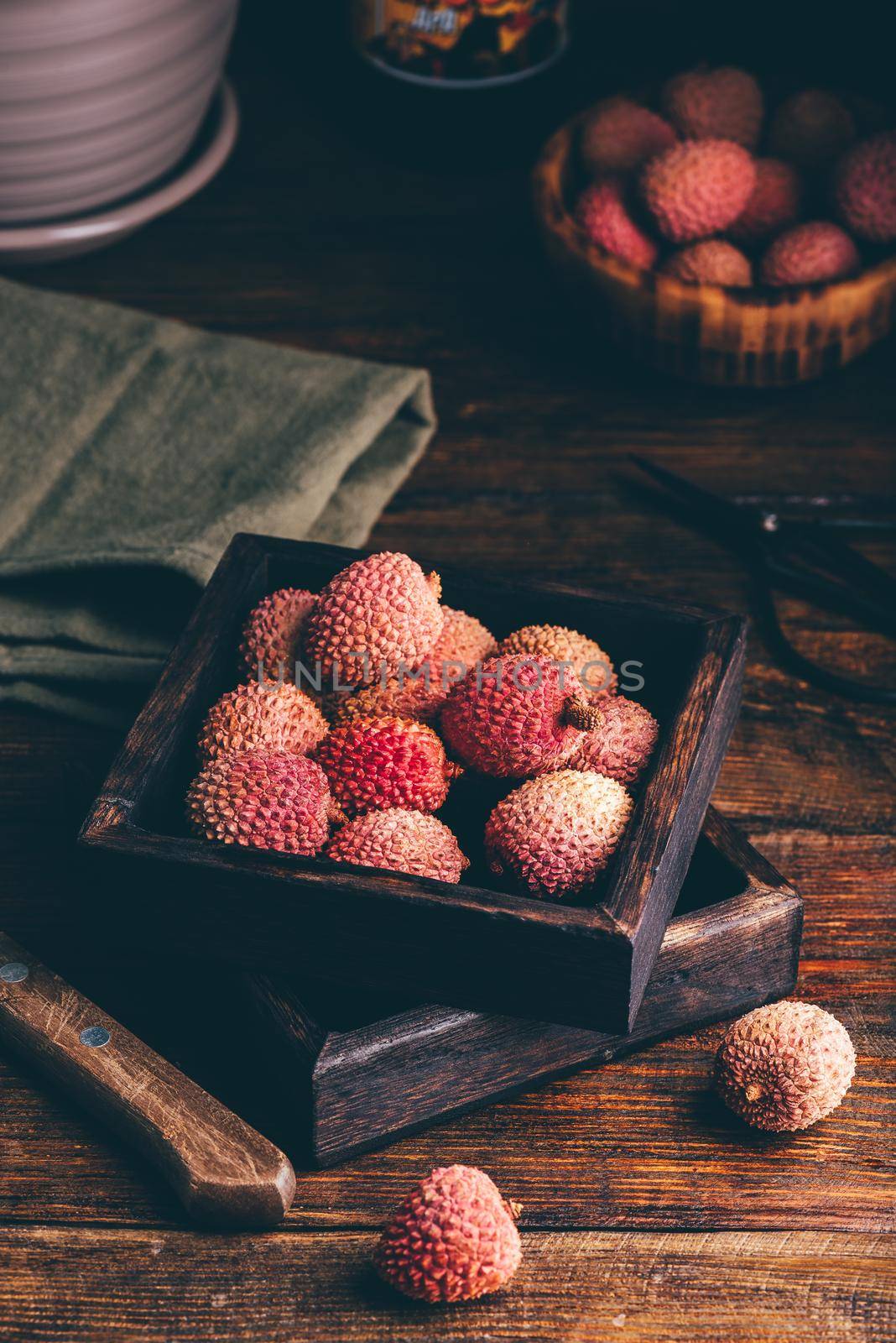 Small Box of Fresh Lychees on Wooden Table