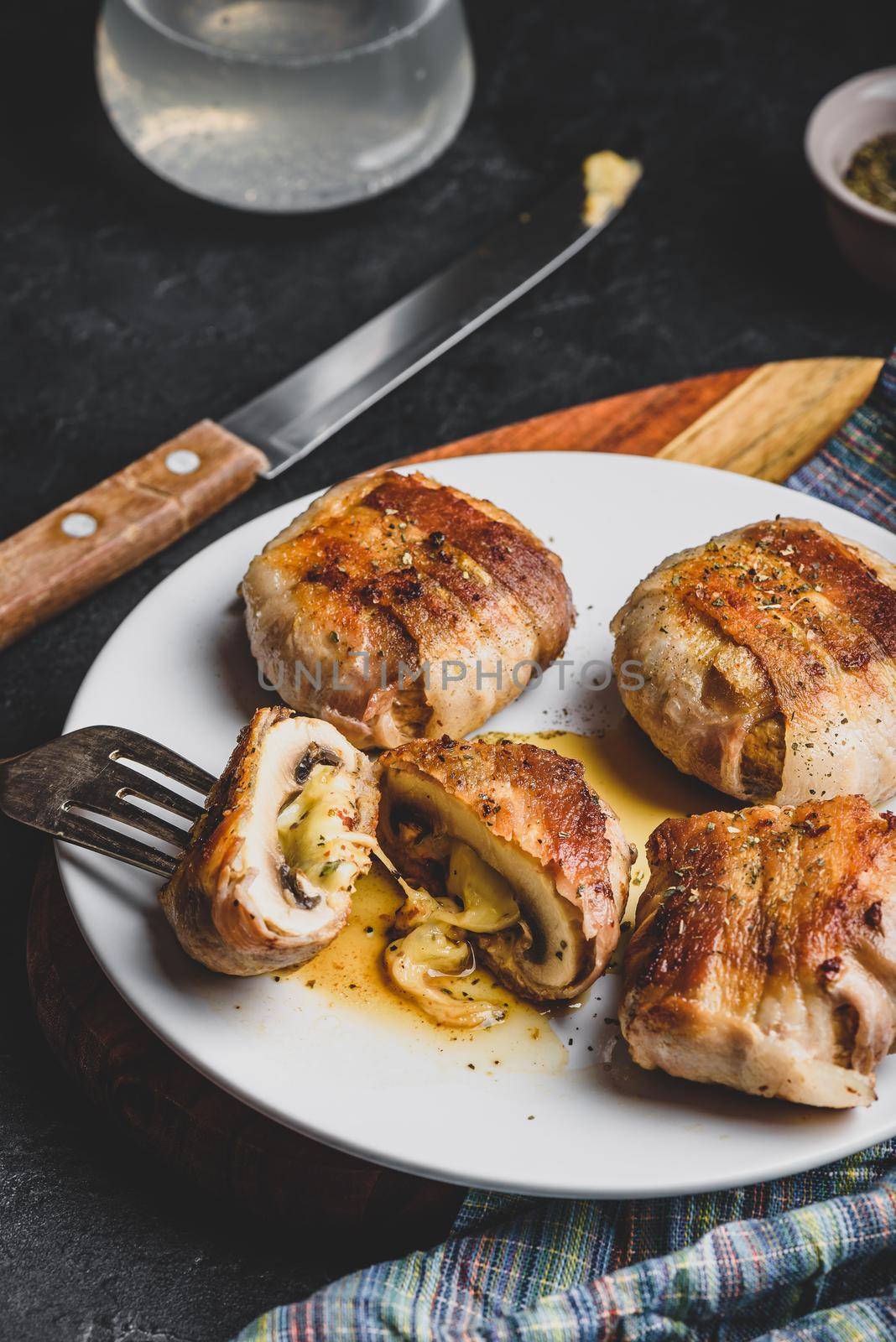 Bacon-wrapped button mushrooms stuffed with grated cheddar cheese and spices