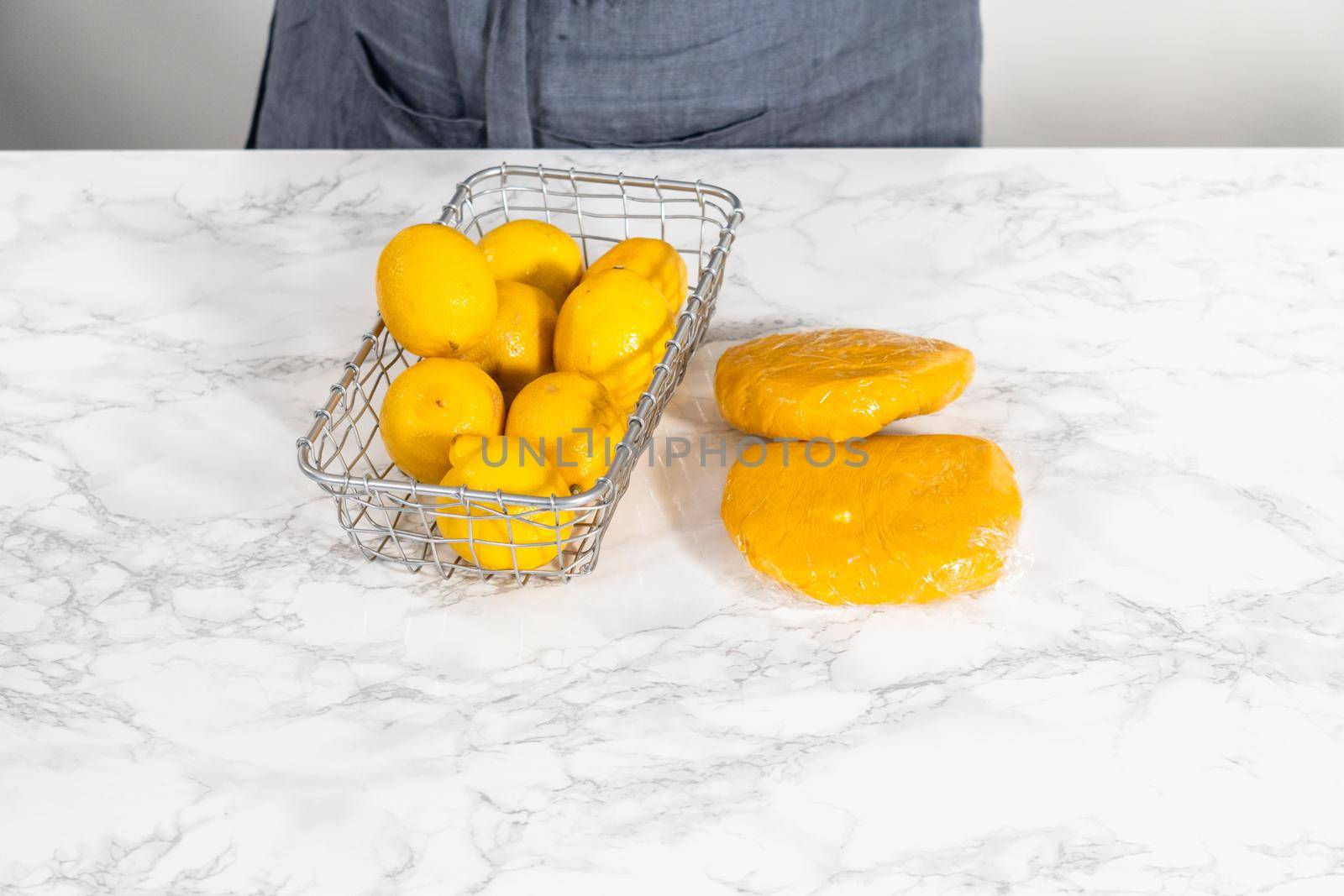 Lemon wedge cookies with lemon glaze. Wrapping cookie dough for chilling in the refrigerator to bake lemon wedge cookies with lemon glaze.