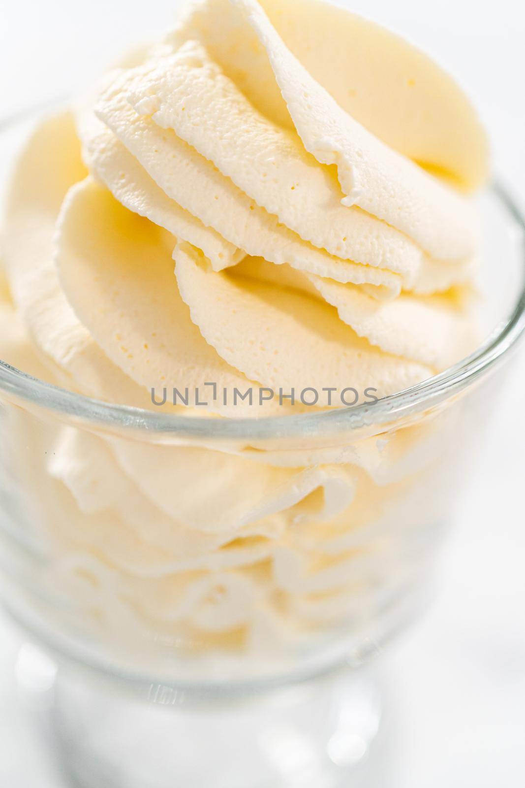 Homemade whipped cream in a class ice cream bowl.