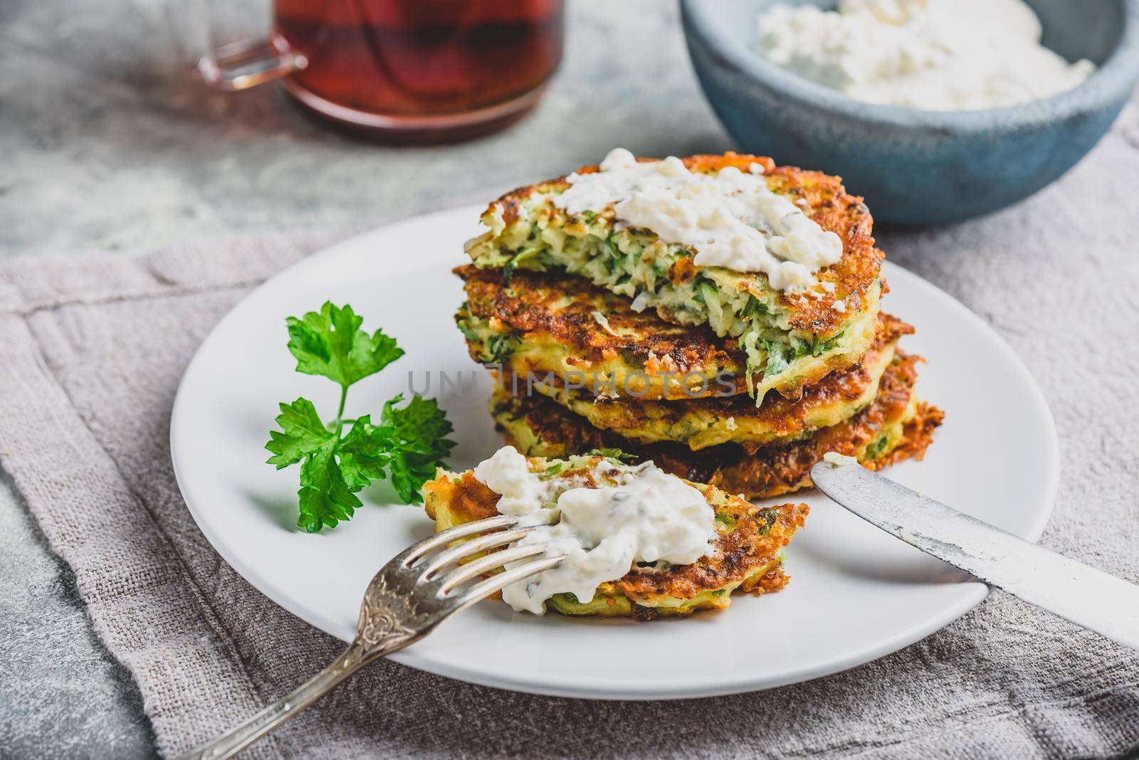 Zucchini parmesan pancakes with dip and parsley