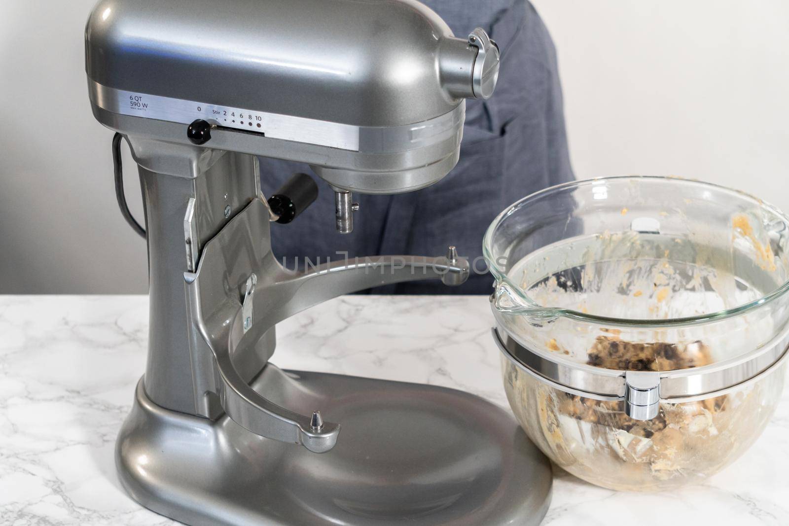 Mixing ingredients in a kitchen stand mixer to bake soft oatmeal raisin walnut cookies.