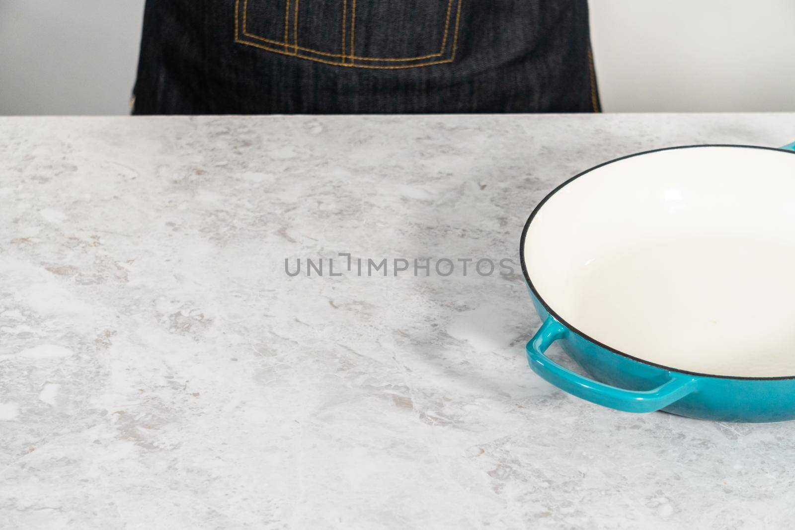 Clean cast iron enameled braiser on the kitchen counter.