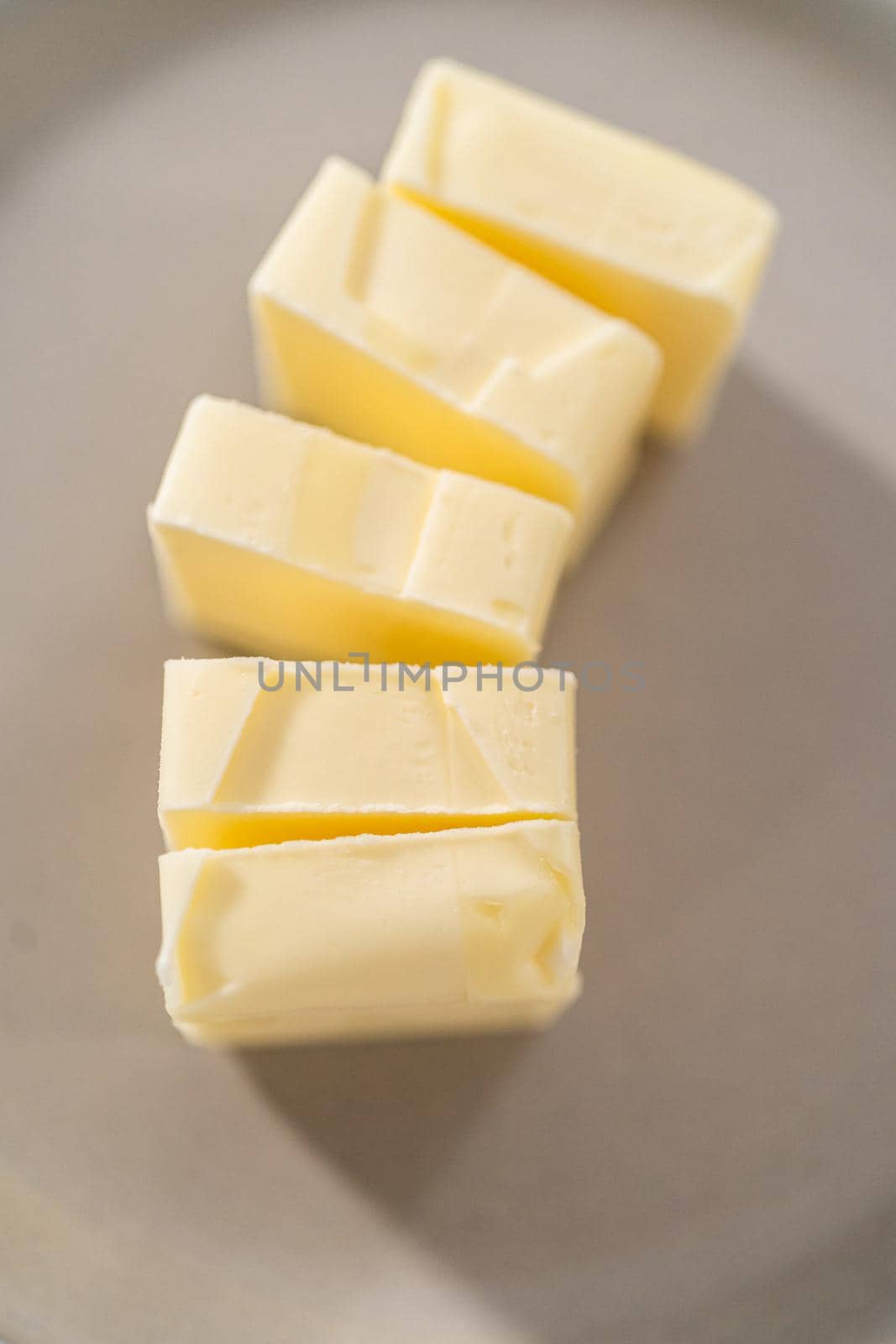 Softened sticks of unsalted butter on the kitchen counter.