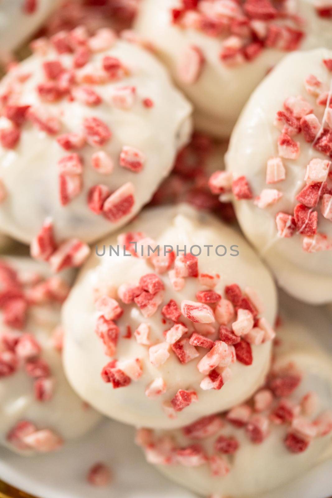 Freshly baked peppermint white chocolate cookies on a white plate.