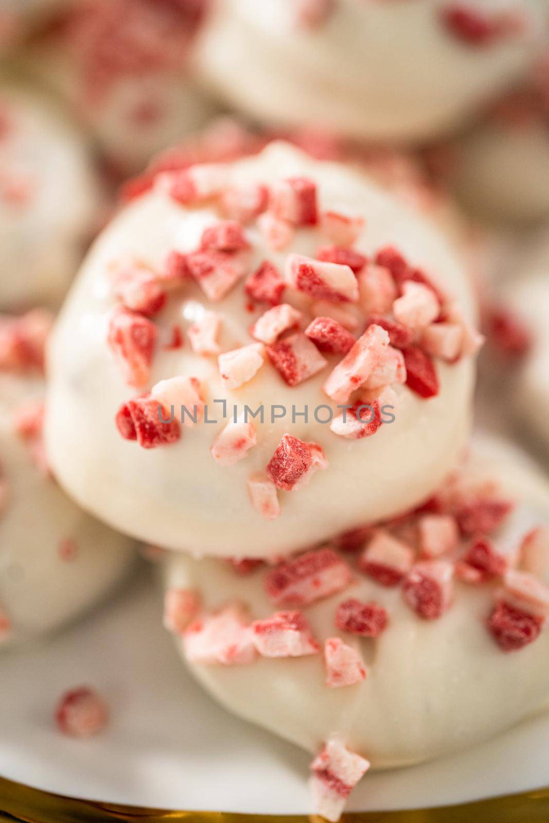 Freshly baked peppermint white chocolate cookies on a white plate.