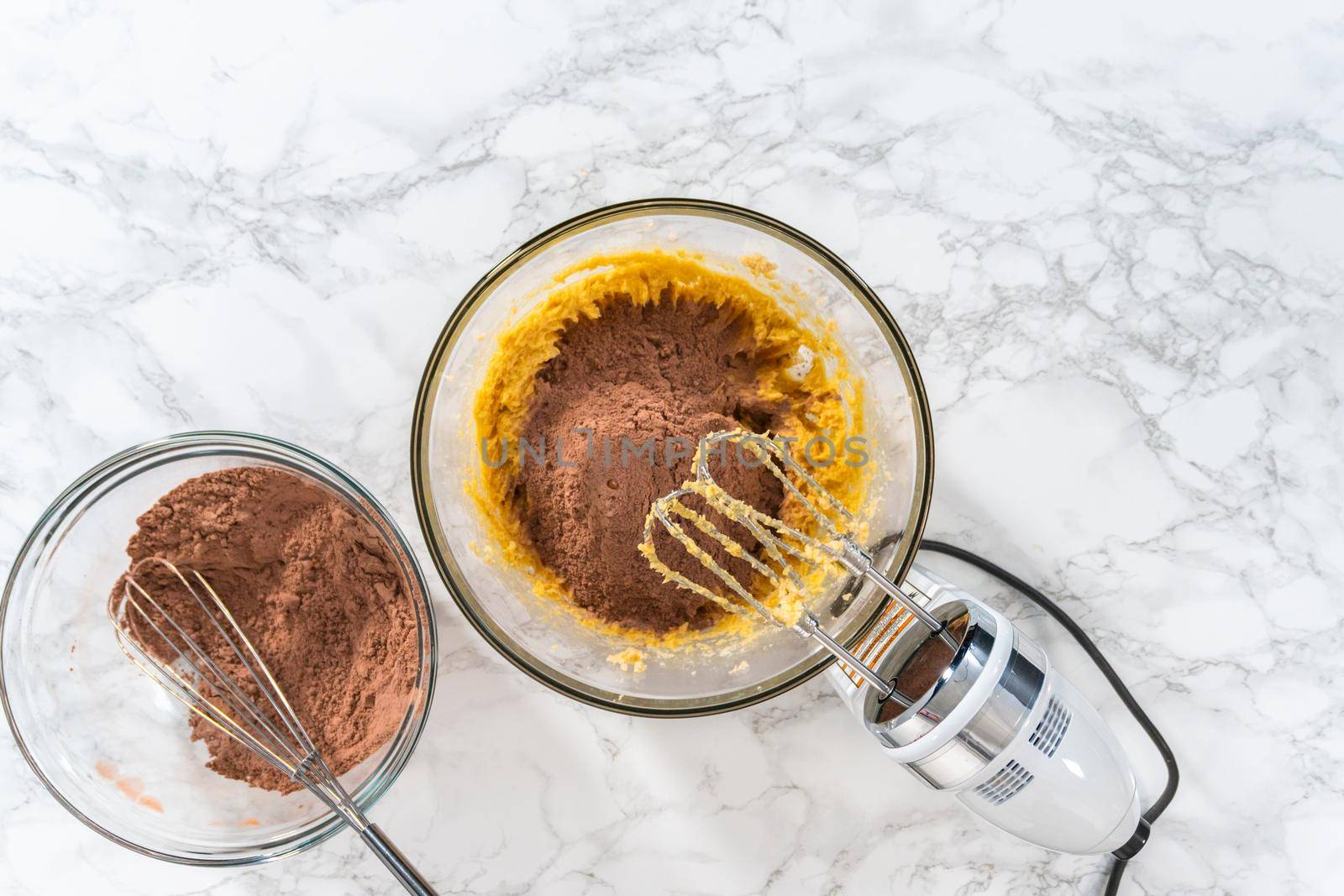 Flat lay. Mixing ingredients in a large glass mixing bowl to bake peppermint white chocolate cookies.