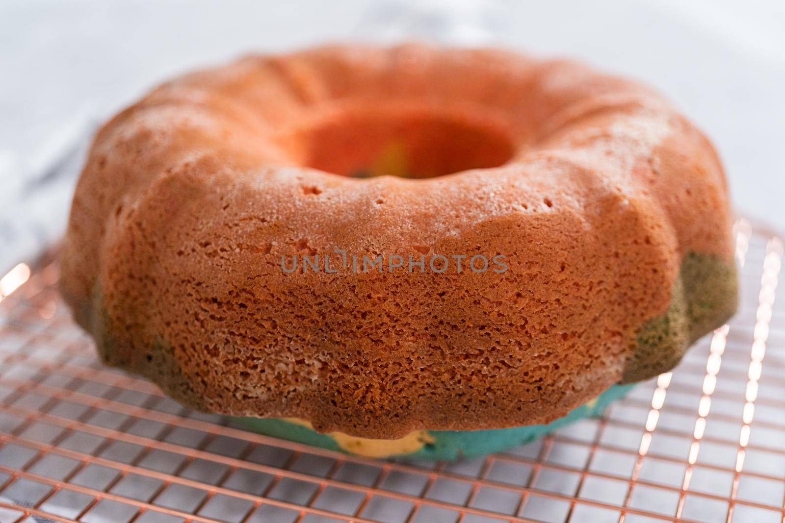 Cooling freshly baked bundt cake on a round cooling rack.