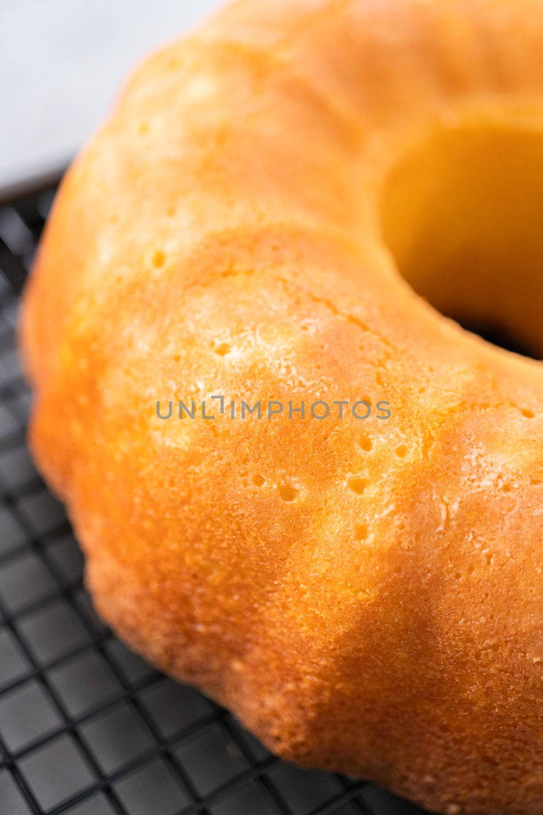 Cooling lemon cranberry bundt cake on a kitchen drying rack.