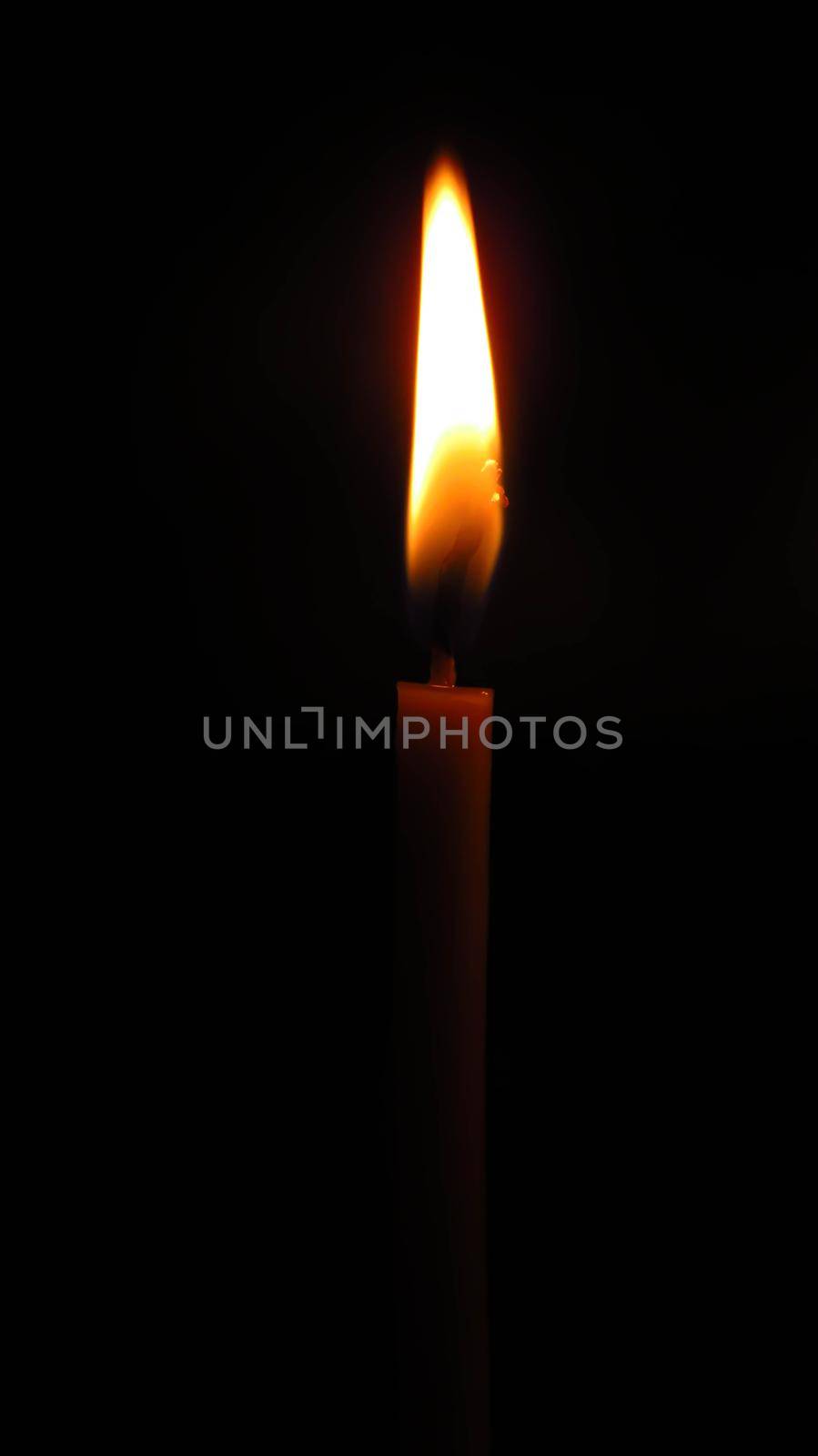 mysterious church candle on a dark background.