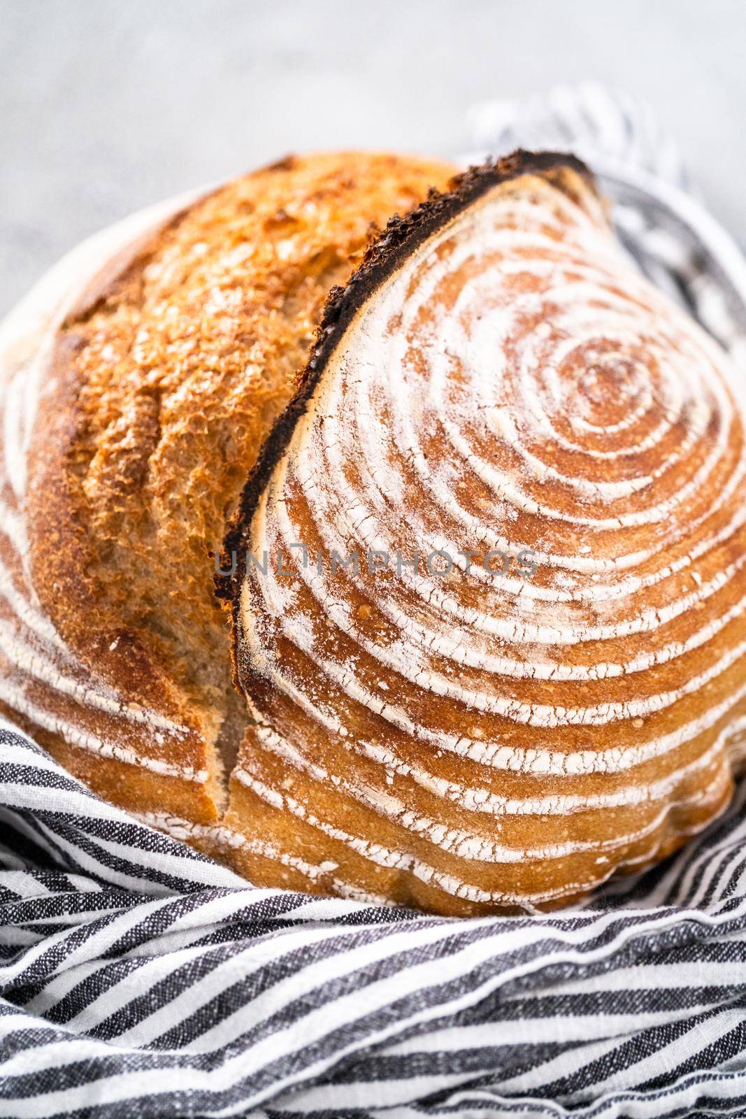 Freshly baked loaf of a wheat sourdough bread with marks from bread proofing basket.