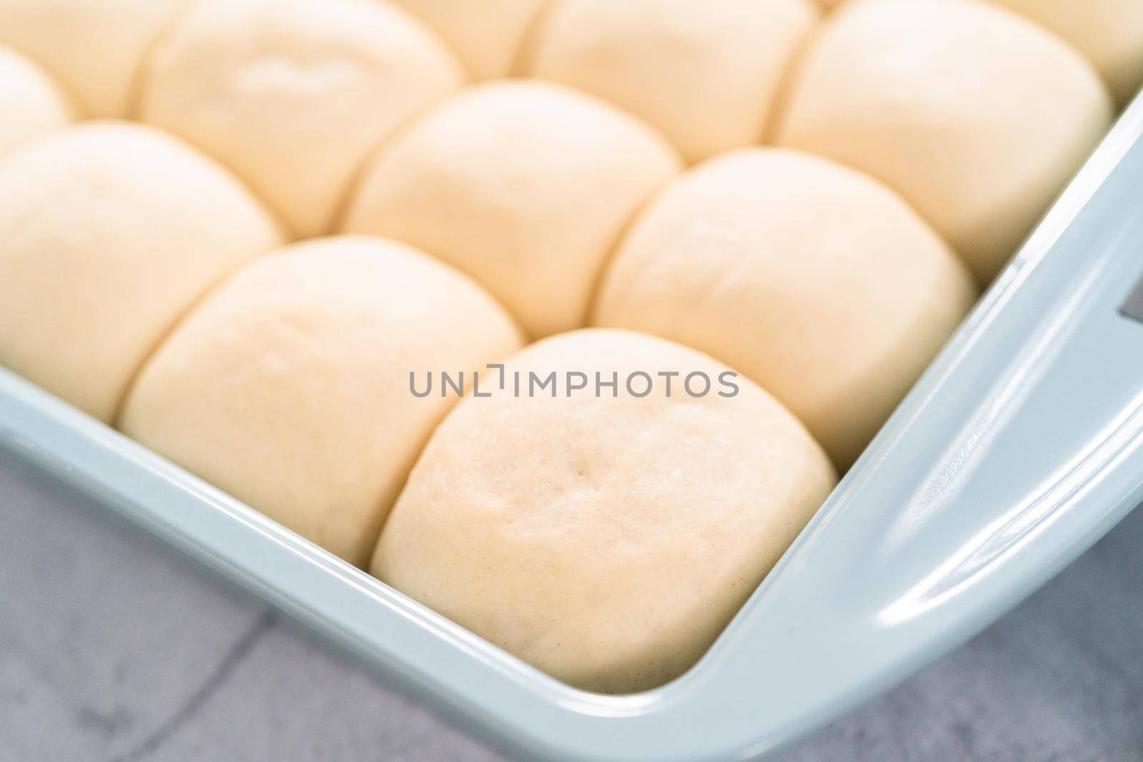 Rizing dinner rolls in an the baking pan.