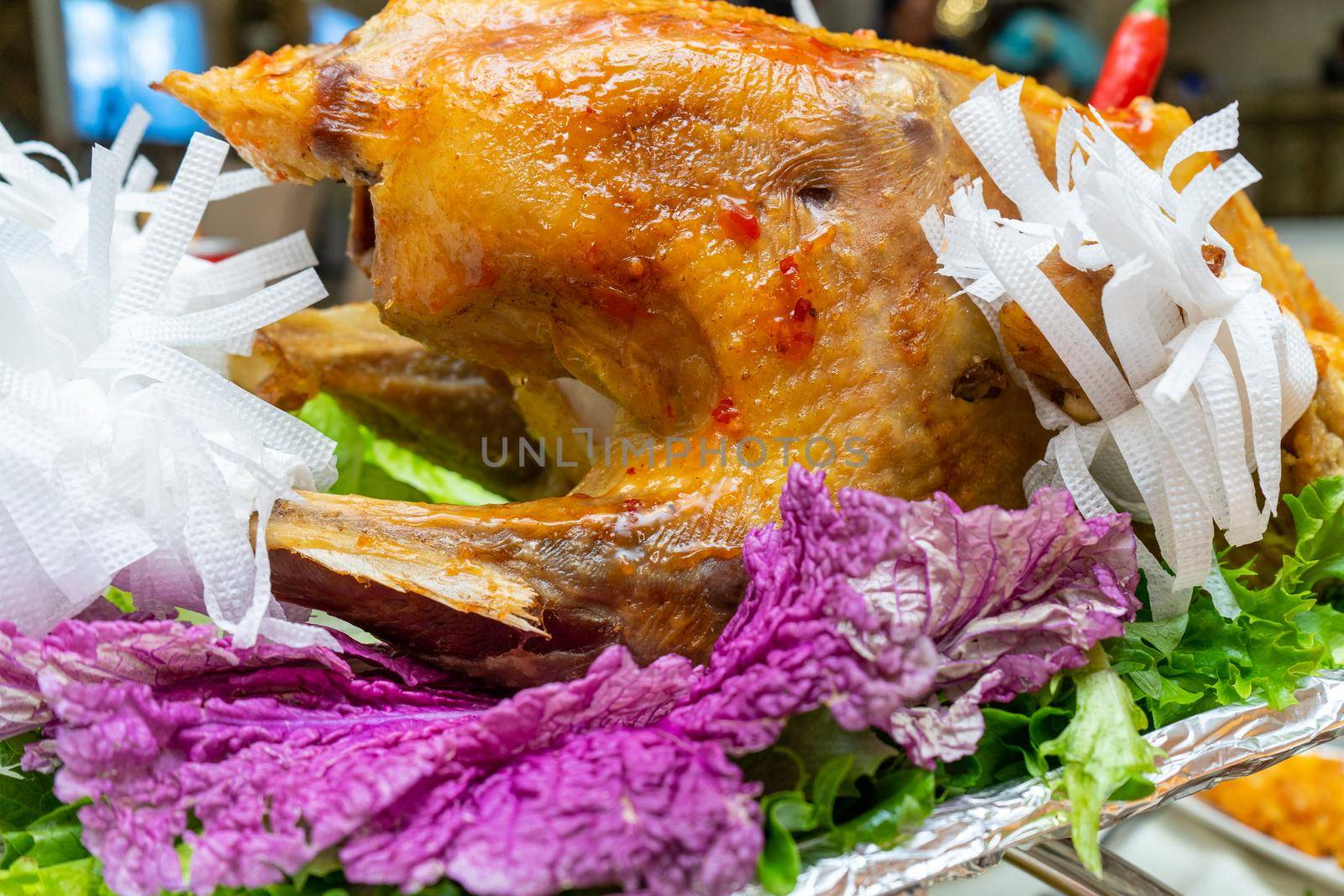 A large roast turkey on the holiday table at Thanksgiving.