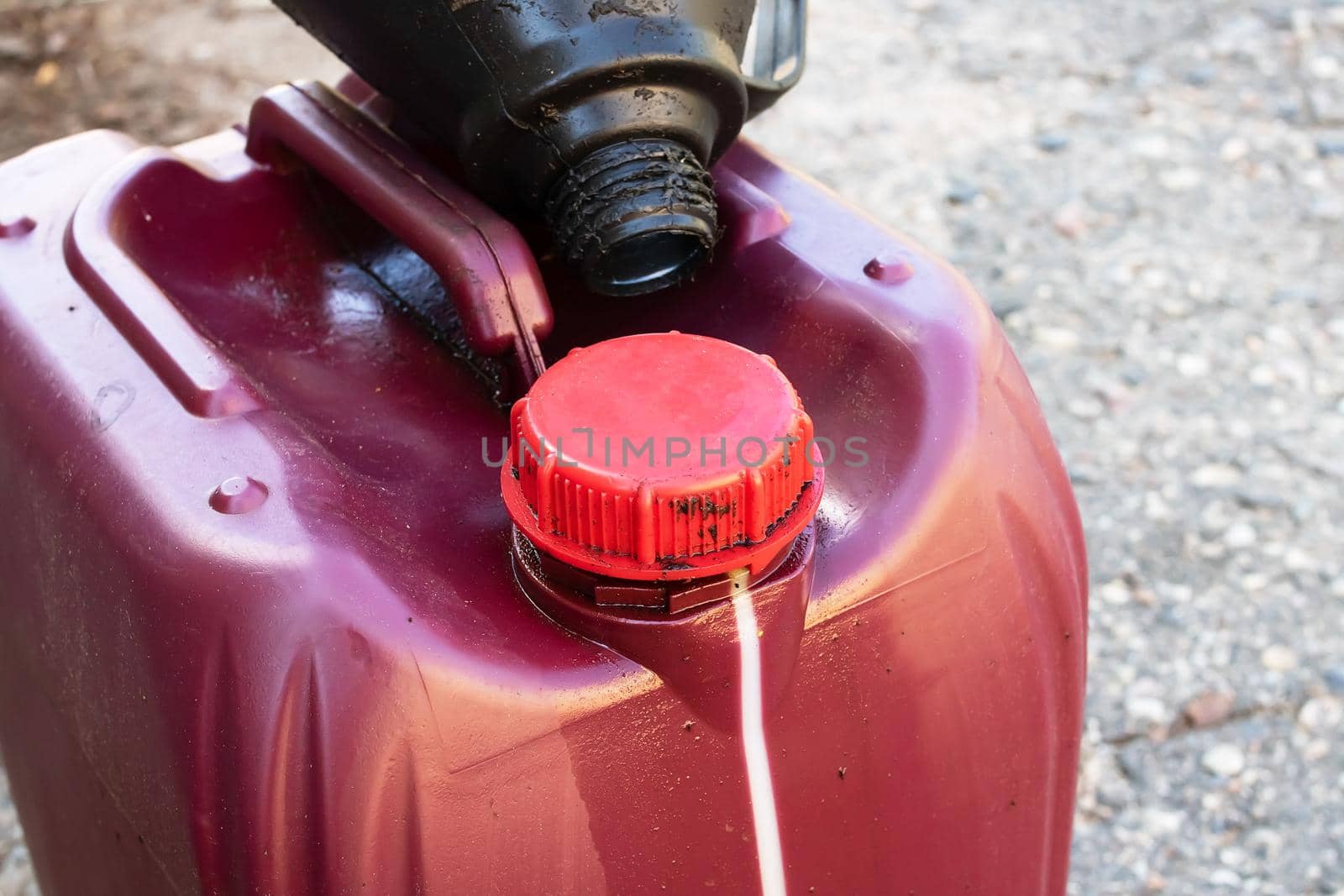 Large red canister of engine oil close up