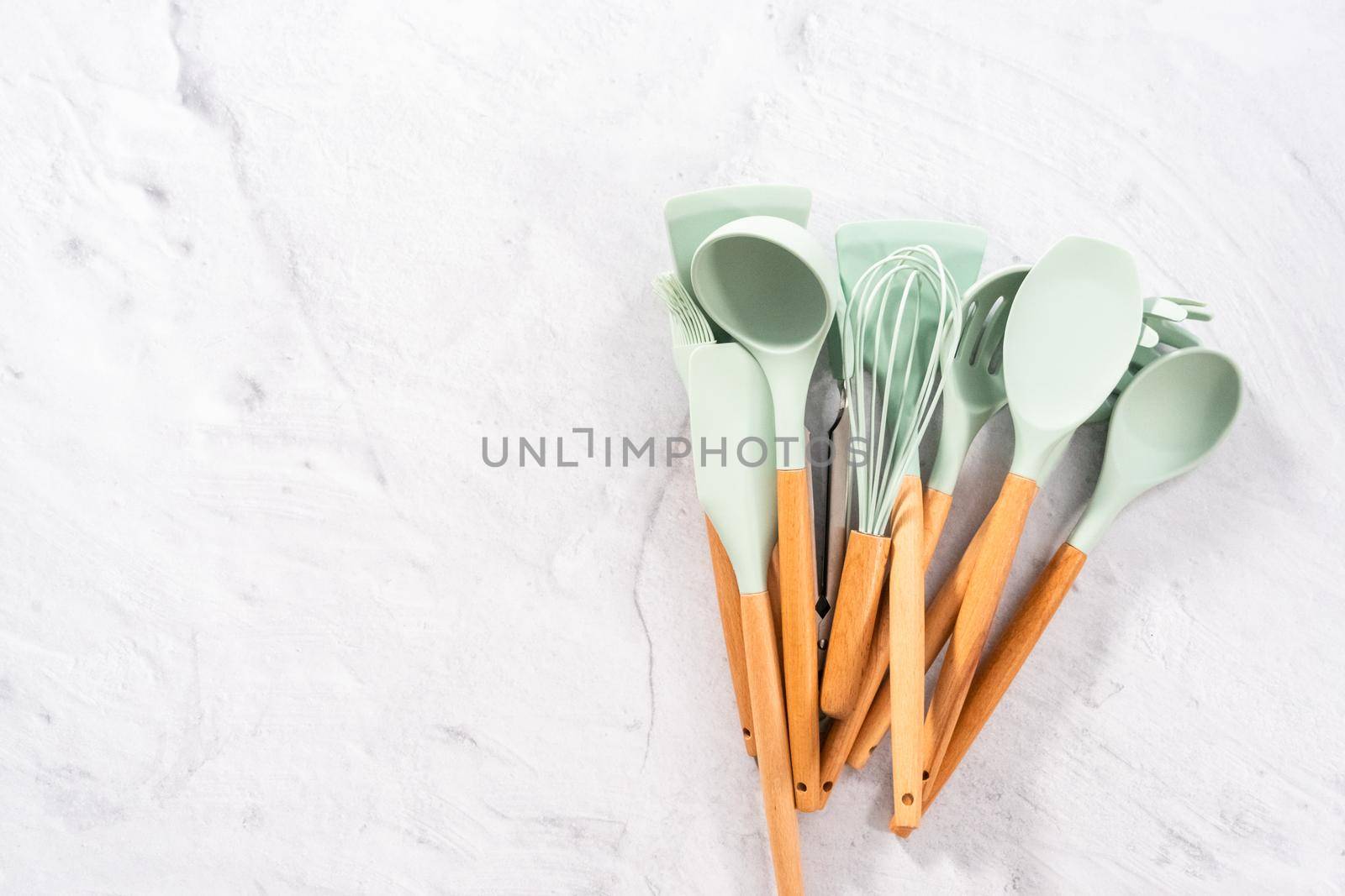 Flat lay. Silicone cooking utensils with wooden handle.