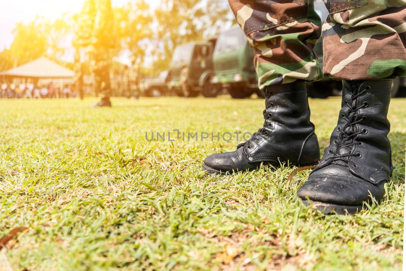 Boots of an unrecognizable Latin American soldier in a field in a military formation