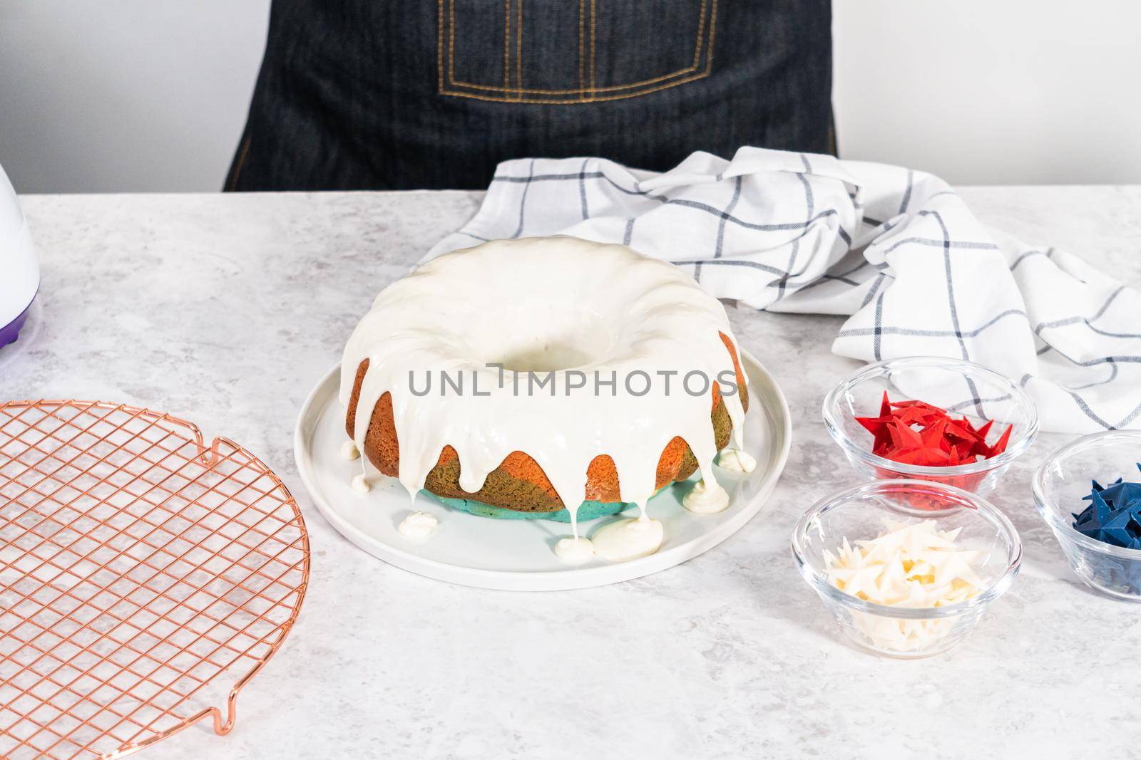 Glazing freshly baked bundt cake with vanilla glaze.