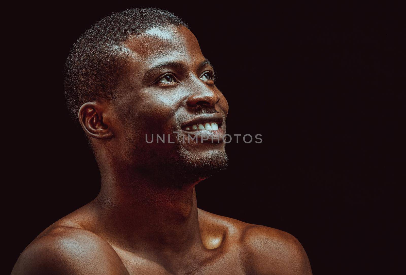 Black african man smile studio in beautiful style on black background. Black background. Isolated studio portrait. Beautiful model.