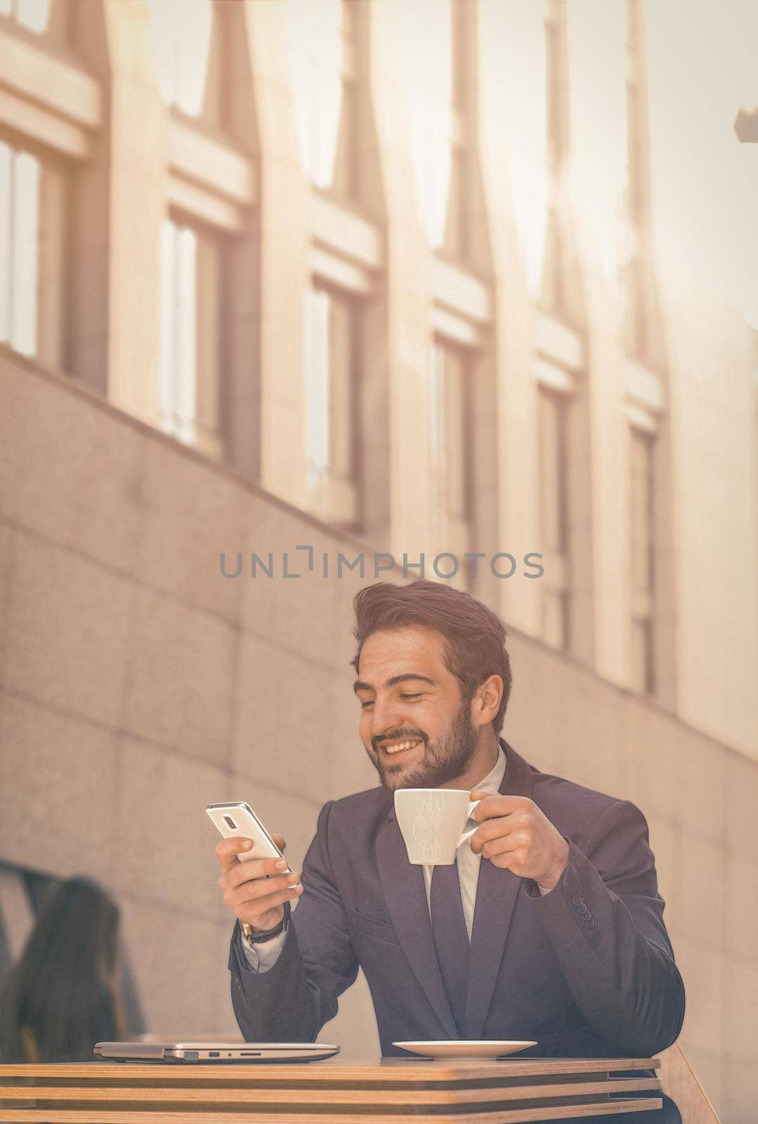 happy manager has online call on phone in cafe for mobile device design. Coffee shop concept. Business technology. Smartphone lifestyle by LipikStockMedia