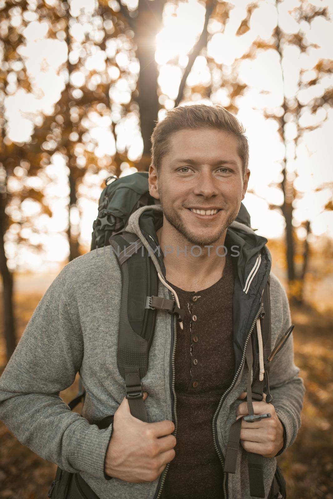 Traveler With Backpack Walks In Autumn Forest by LipikStockMedia