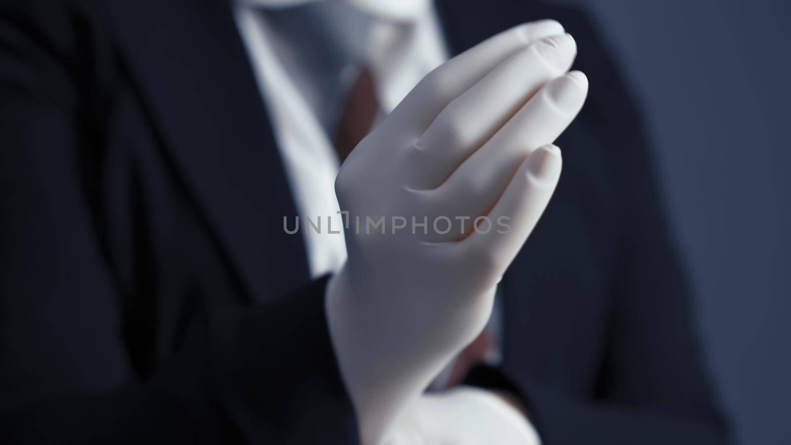 Business person puts on white disposable gloves. Business during and after quarantine. Close up shot.