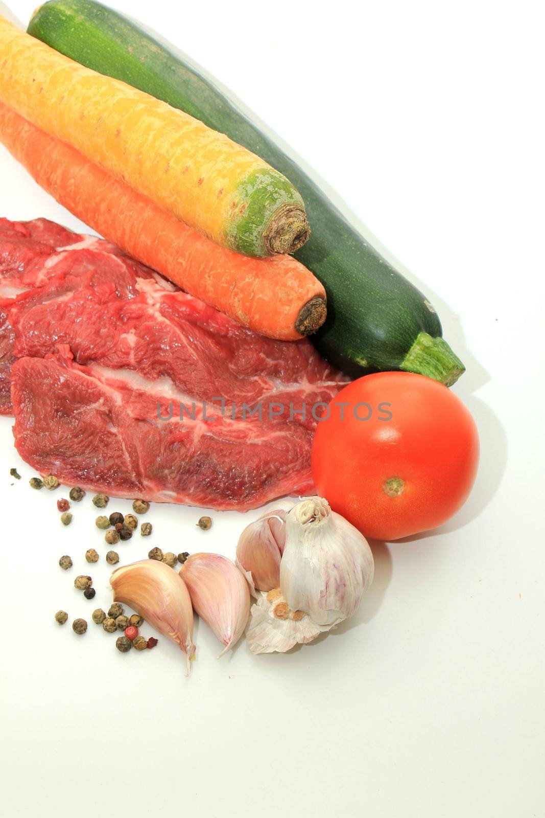 Raw beef, a zucchini or courgette, some garlic, carrot and a tomato