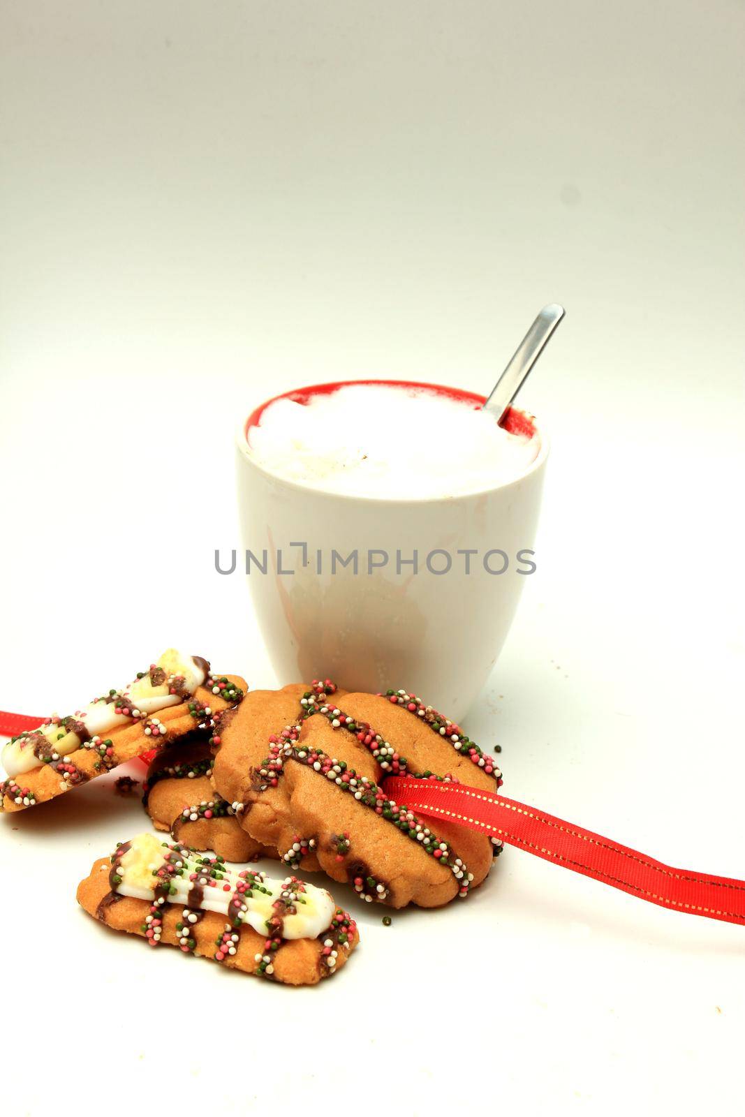 Hot drink and christmas cookies decorated with chocolate and sprinkles by studioportosabbia