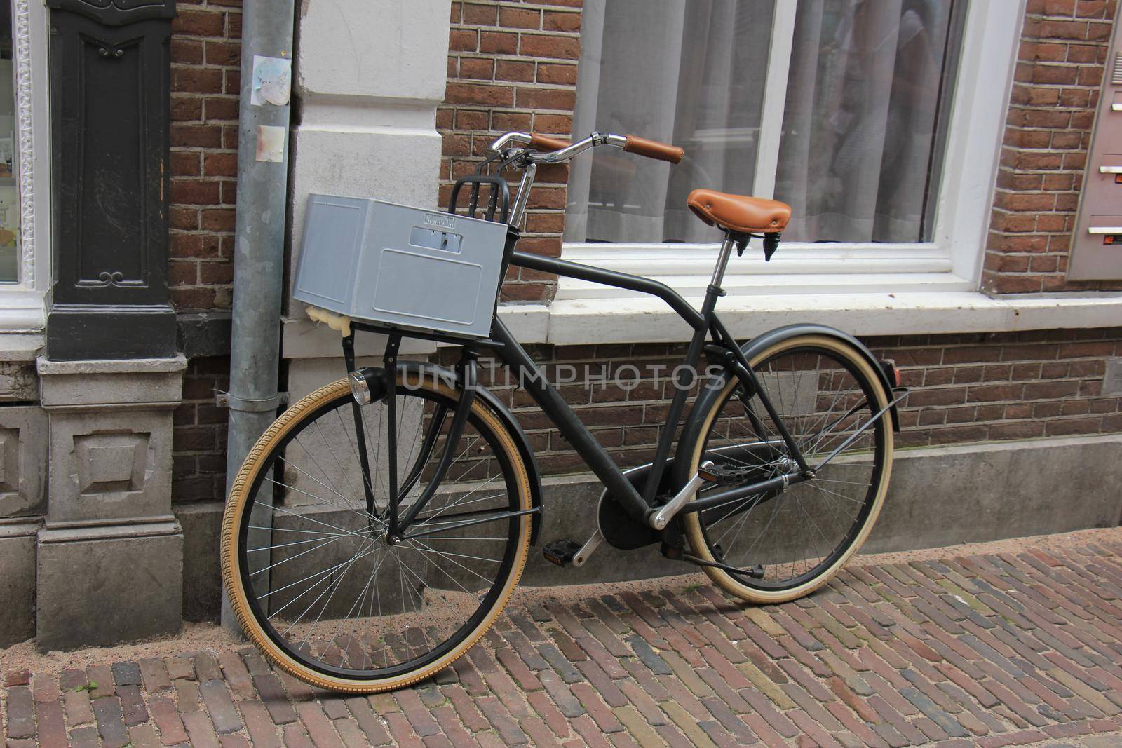 Retro style transportation bike near a brick wall. Plastic beverage crate to carry around the groceries