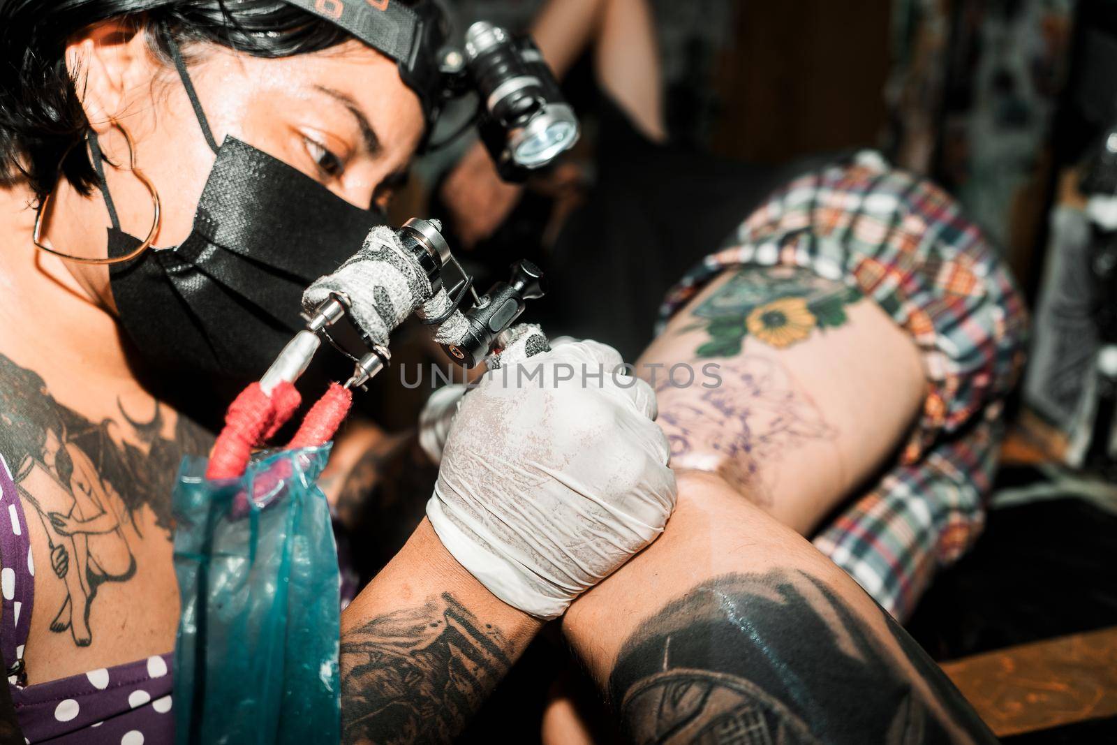 Latin tattoo artist working. Direct front flash hard light photo by cfalvarez