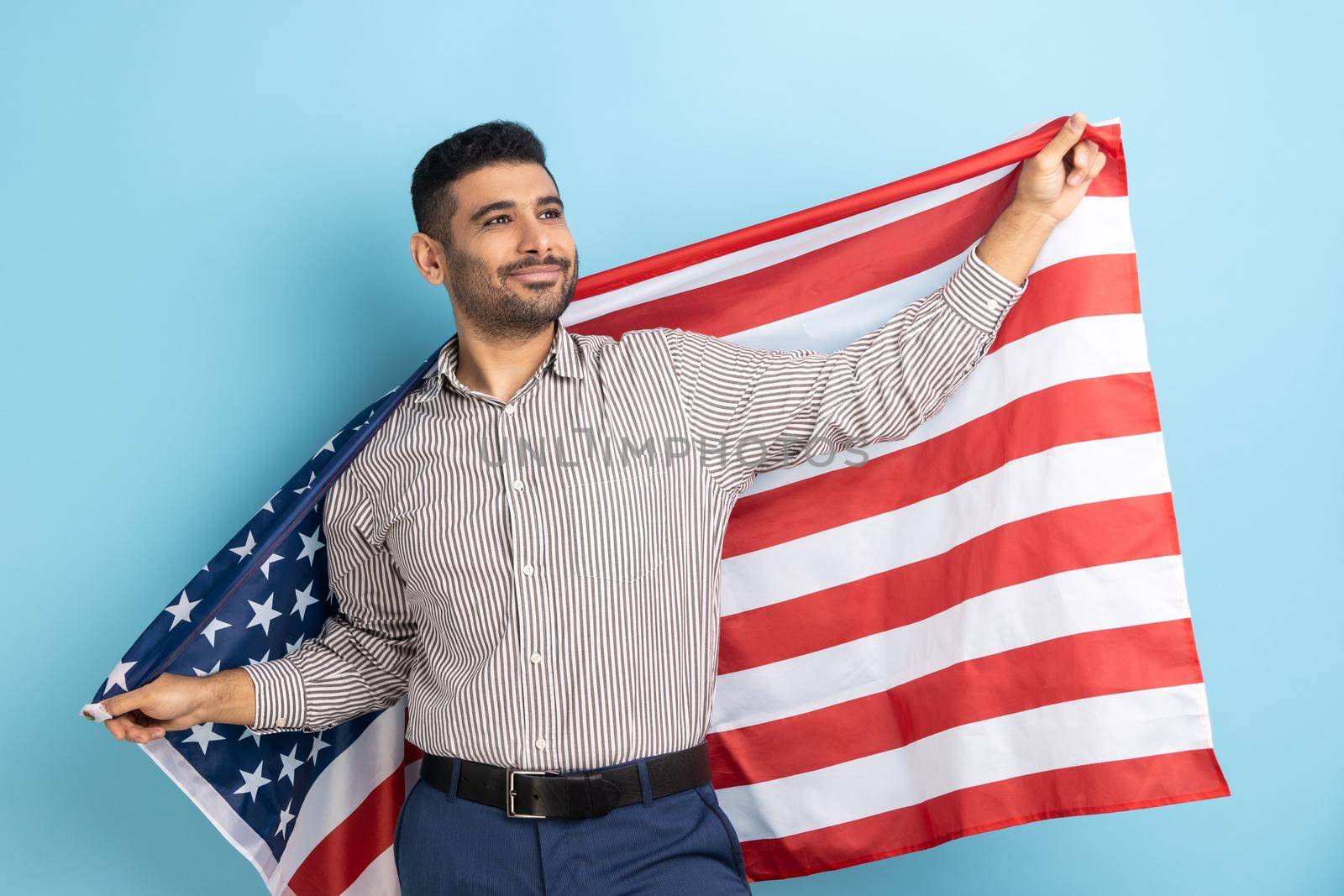 Man holding USA flag looking away with confident expression, proud of his social security in country by Khosro1