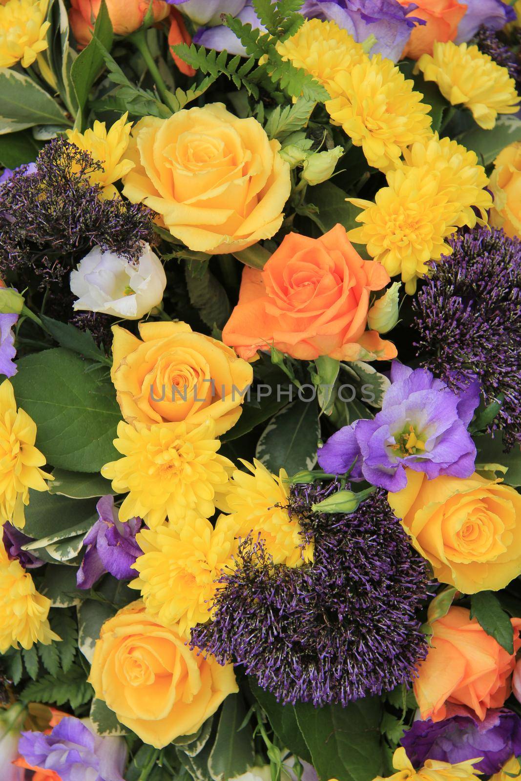 Mixed flower arrangement: various flowers in yellow, orange and purple for a wedding by studioportosabbia