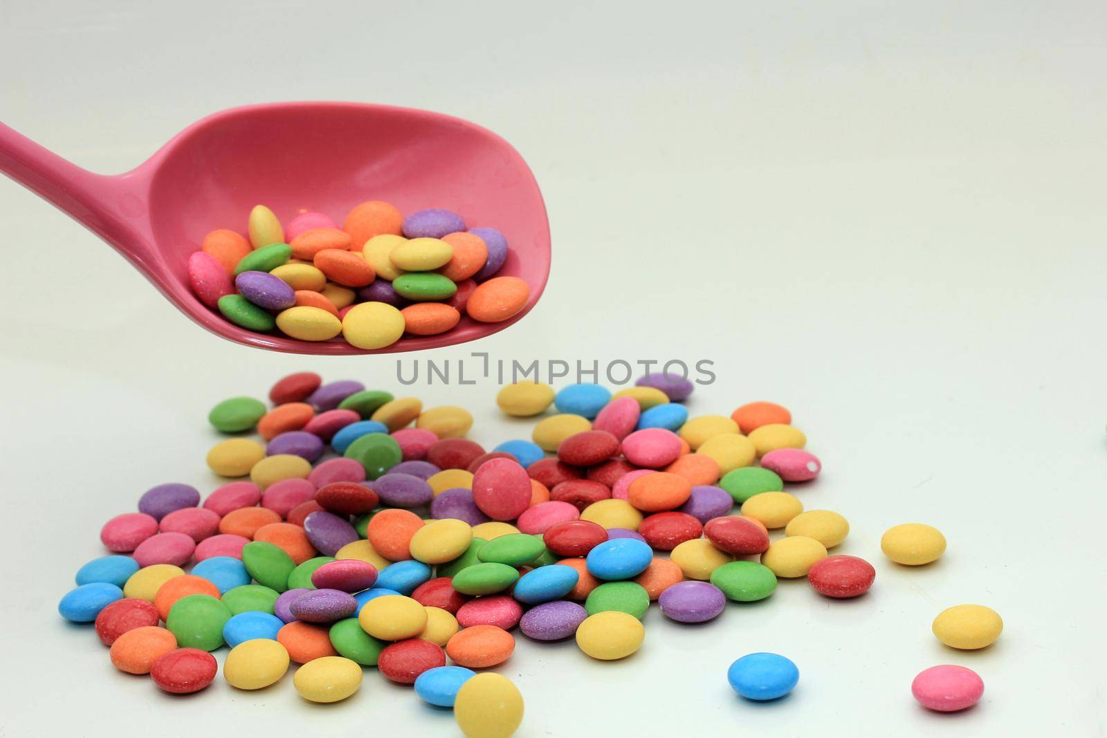 Chocolate filled candies in various bright colors by studioportosabbia